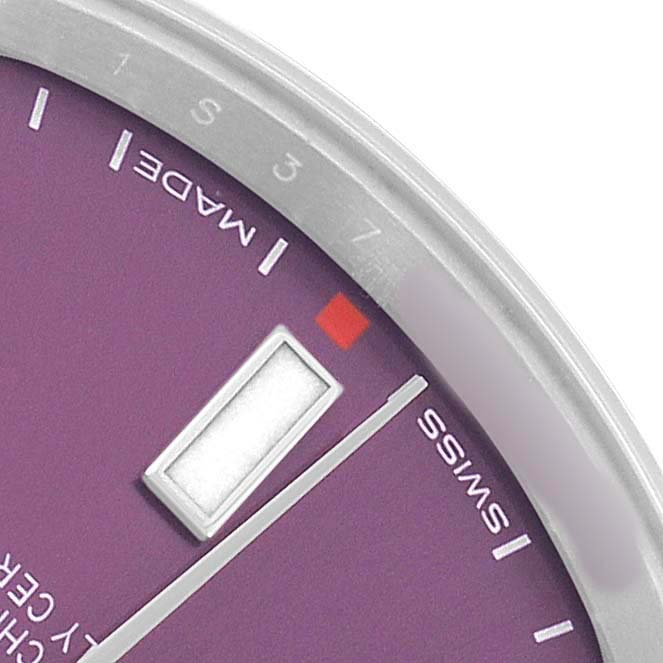 The image shows a close-up of the Oyster Perpetual by Rolex, highlighting the dial, minute marker, and part of the bezel from an angled view.