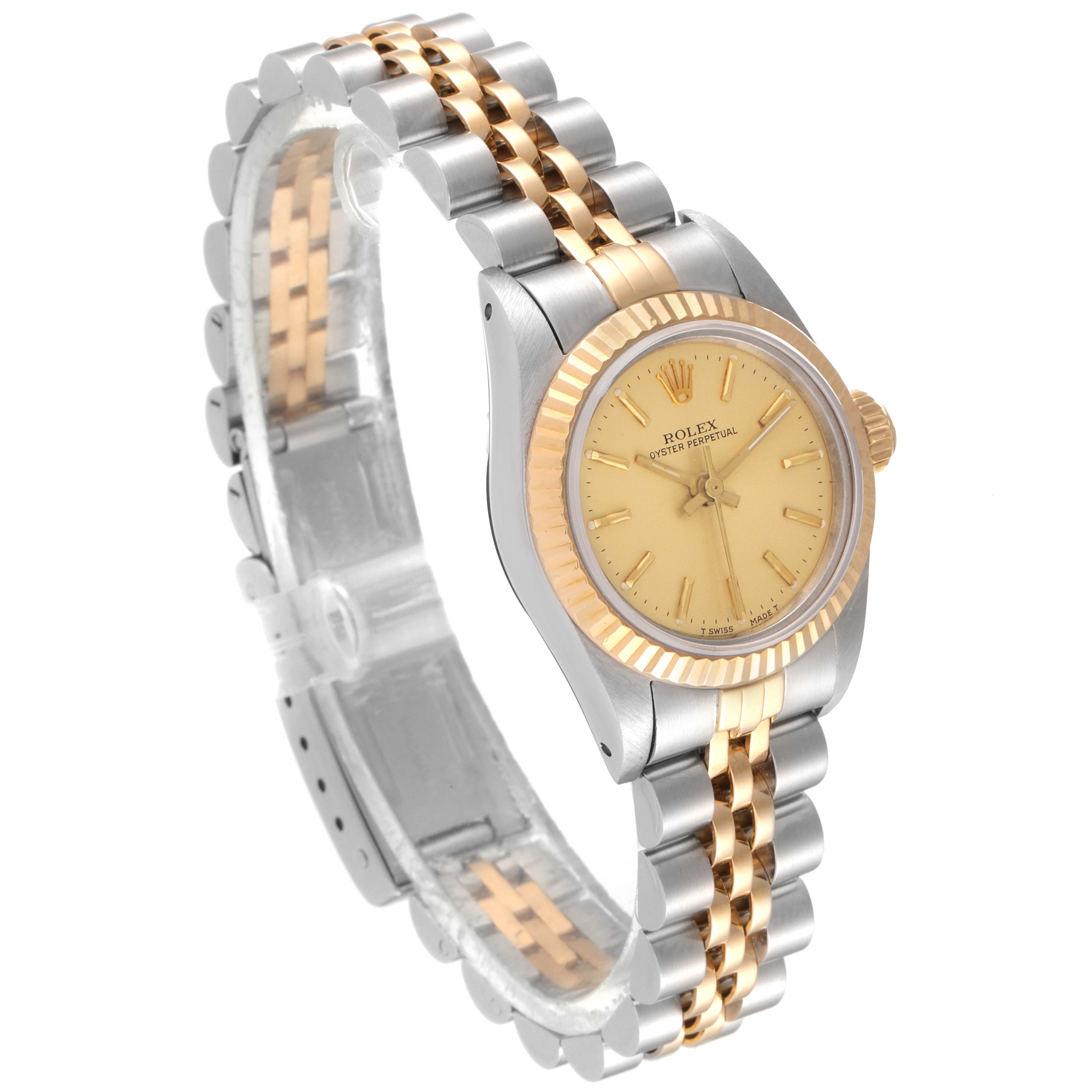 This image shows a side and slightly angled view of a Rolex Oyster Perpetual 67193 Women
s Steel and Gold (two tone) Champagne Dial 67193 Women
s Steel and Gold (two tone) Champagne Dial with a two-tone metal band and a gold dial.