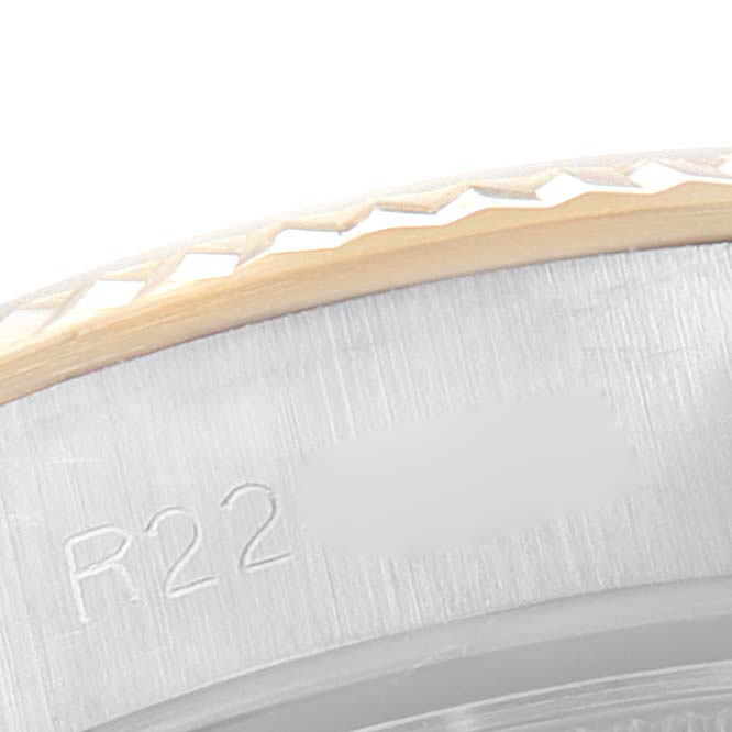 This close-up image shows the edge and part of the engraved inner bezel of the Rolex Oyster Perpetual 67193 Women
s Steel and Gold (two tone) Champagne Dial 67193 Women
s Steel and Gold (two tone) Champagne Dial watch.