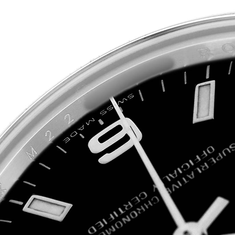 The image shows a close-up of the Rolex Oyster Perpetual 177200 Women's Stainless Steel Black Dial watch, highlighting part of the dial, the "9" marker, and "Swiss Made" text.