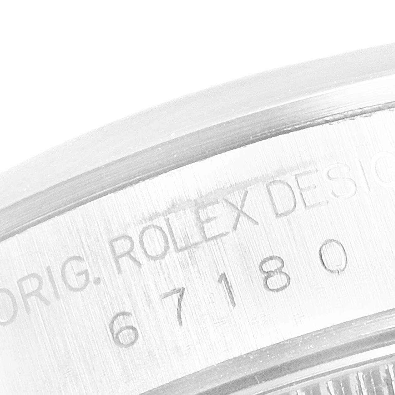 This close-up image shows the engraved text on the outer edge of the Rolex Oyster Perpetual 67180 Women's Stainless Steel Pink Dial 67180 Women's Stainless Steel Pink Dial watch casing.