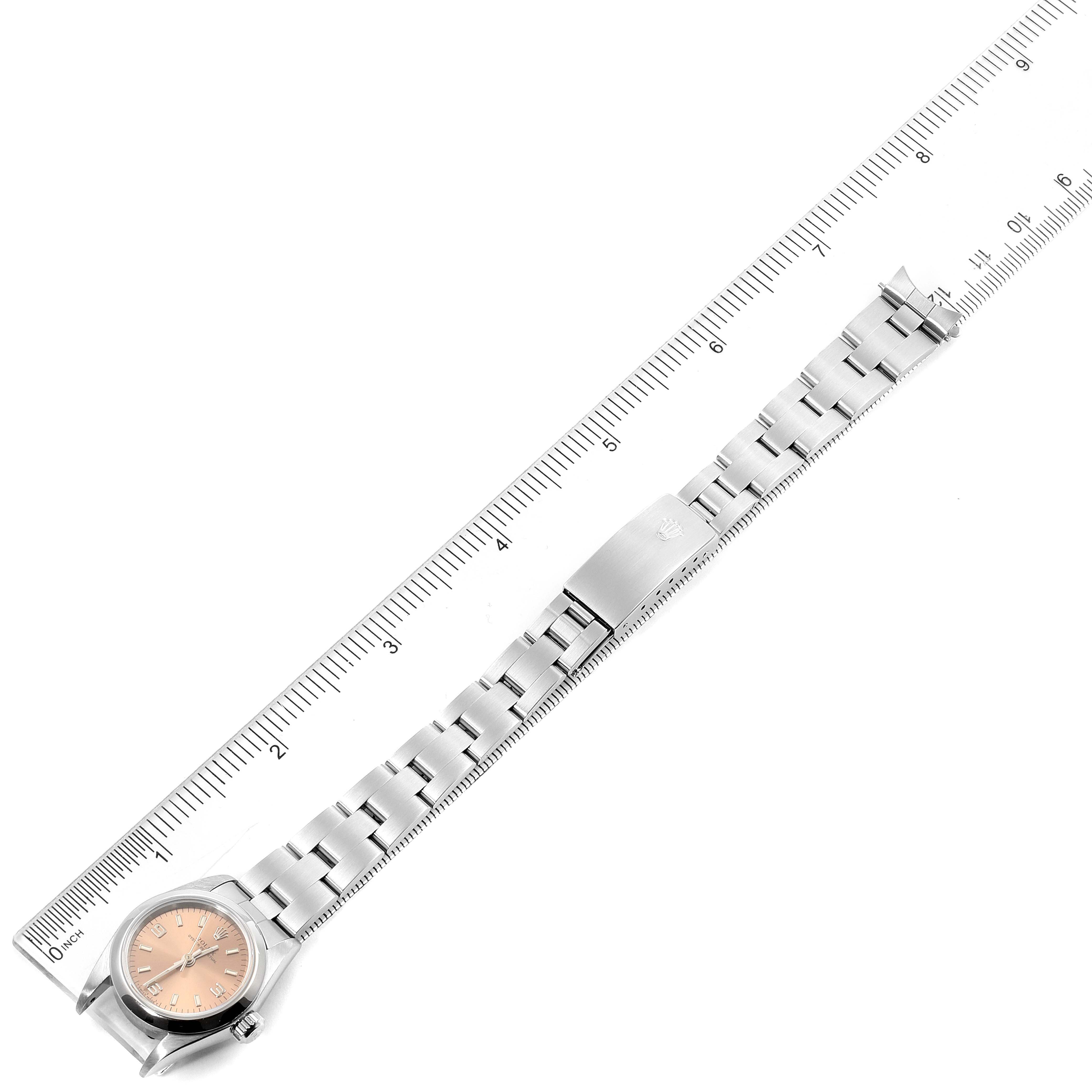The image shows a Rolex Oyster Perpetual 67180 Women's Stainless Steel Pink Dial 67180 Women's Stainless Steel Pink Dial watch, laid flat with its bracelet extended alongside a ruler for measurement.