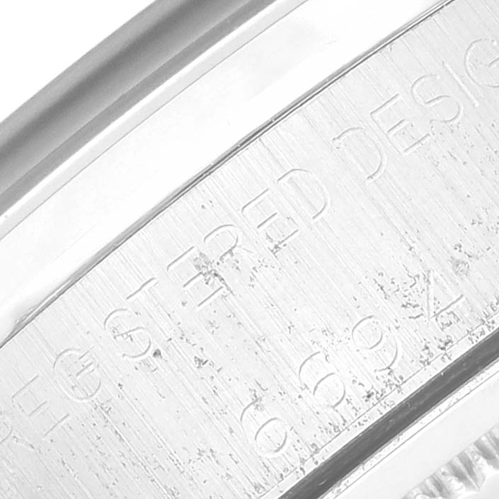 This close-up image shows the engraved details on the side of the bezel of a Rolex Vintage Collection 6694 Men's Stainless Steel Champagne Dial 6694 Men's Stainless Steel Champagne Dial watch.