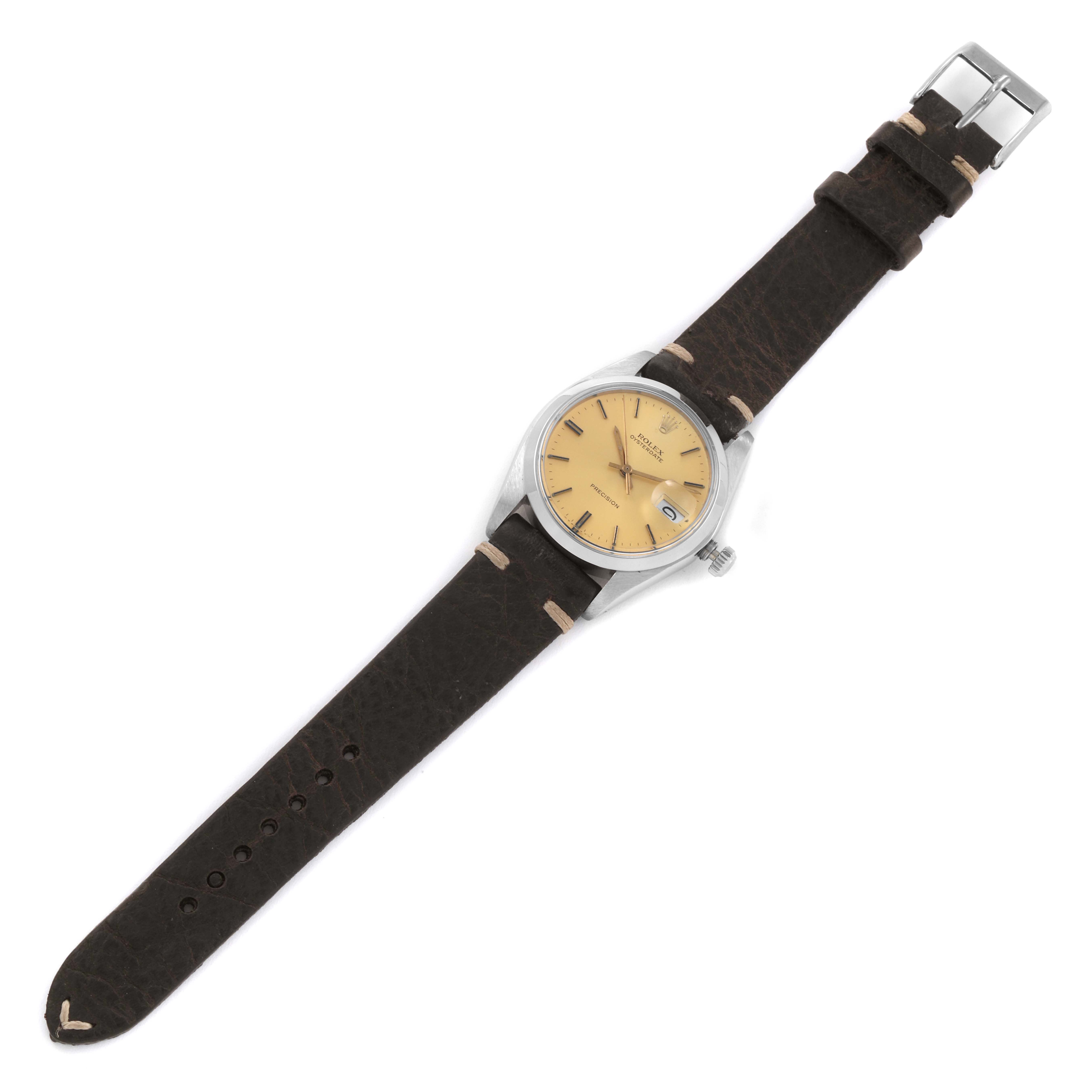 The image shows a full view of a Rolex Vintage Collection 6694 Men's Stainless Steel Champagne Dial 6694 Men's Stainless Steel Champagne Dial watch with a tan dial and brown leather strap from a top-down angle.