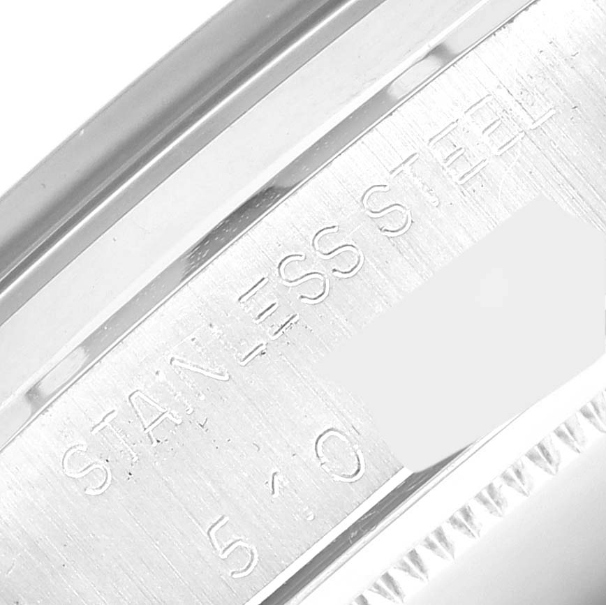 The image shows a close-up of the side engraving on the Rolex Vintage Collection 6694 Men's Stainless Steel Champagne Dial 6694 Men's Stainless Steel Champagne Dial watch, highlighting the stainless steel material.