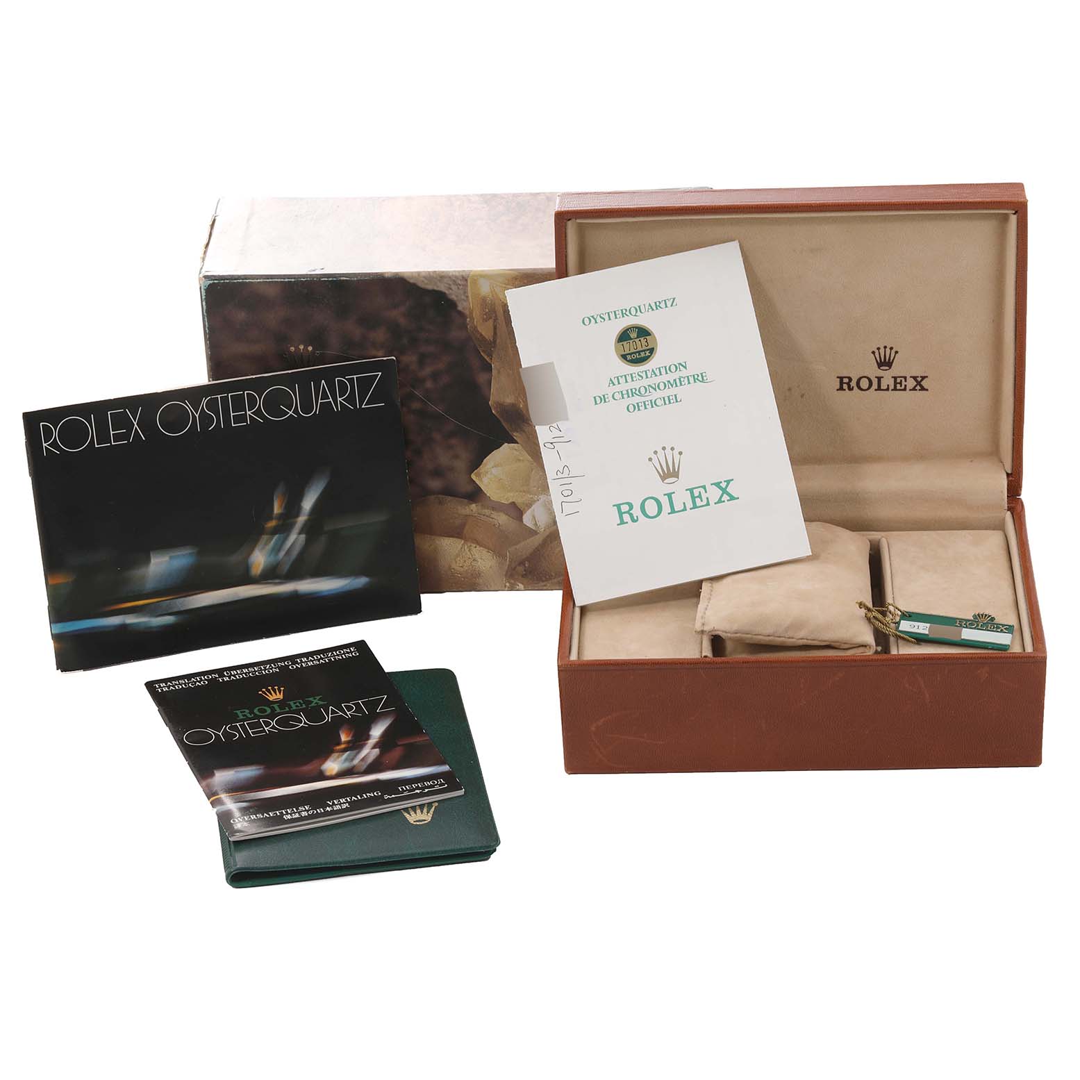 The image shows the packaging and booklets for the Rolex Oysterquartz 17013 Men
s Steel and Gold (two tone) White Dial 17013 Men
s Steel and Gold (two tone) White Dial watch, along with its original box and warranty card.