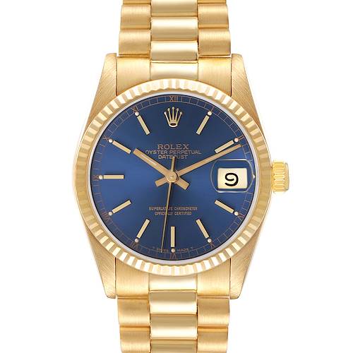 The Rolex President model is shown from the front, displaying the blue dial, fluted bezel, and gold bracelet.