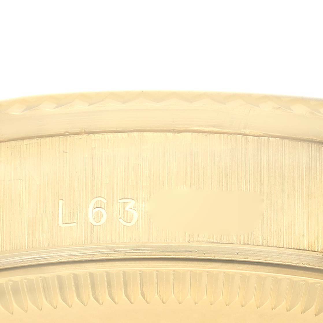 The image shows a close-up of the Rolex President 68278 Women's Yellow Gold Blue Dial 68278 Women's Yellow Gold Blue Dial model's bezel with visible engravings.