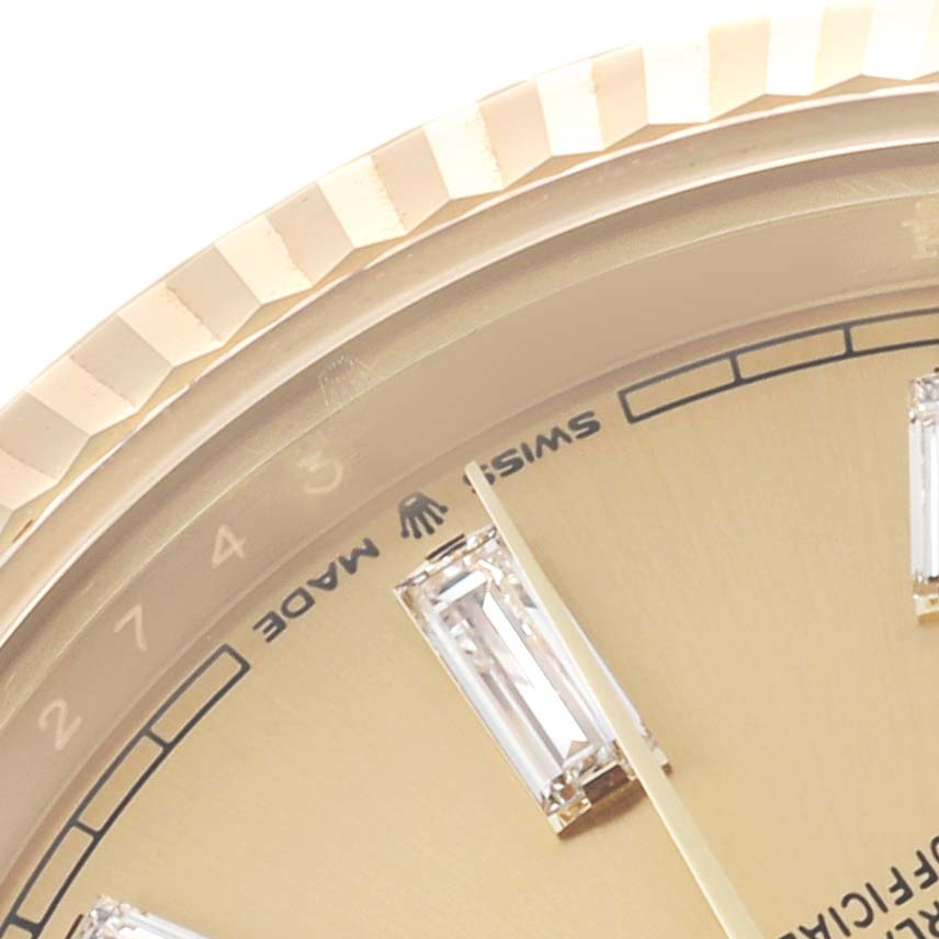 The image shows a close-up of the Rolex President 228238 Men's Yellow Gold Champagne Dial dial, highlighting the bezel, part of the face, and diamond markers.