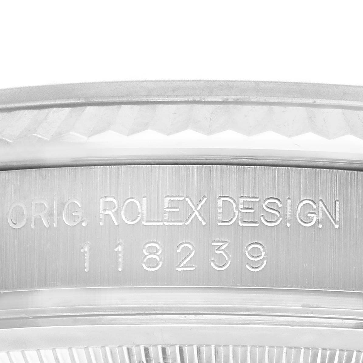 The image shows a side angle of the Rolex President 118239 Men's White Gold Blue Dial 118239 Men's White Gold Blue Dial model, featuring the engraved design and serial number.