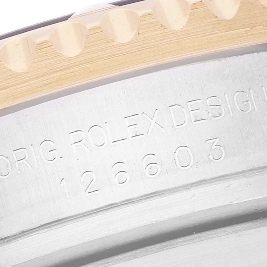 The image shows a close-up of the case back and bezel teeth, revealing the model number and "Rolex Design" engraving of the Rolex Sea-Dweller 126603 Men's Steel and Gold (two tone) Black Dial 126603 Men's Steel and Gold (two tone) Black Dial.