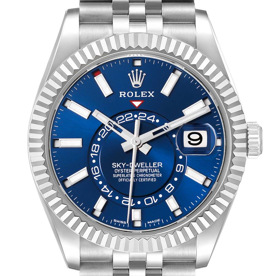 The Rolex Sky-Dweller watch is shown from the front, displaying the blue dial, fluted bezel, and oyster bracelet.