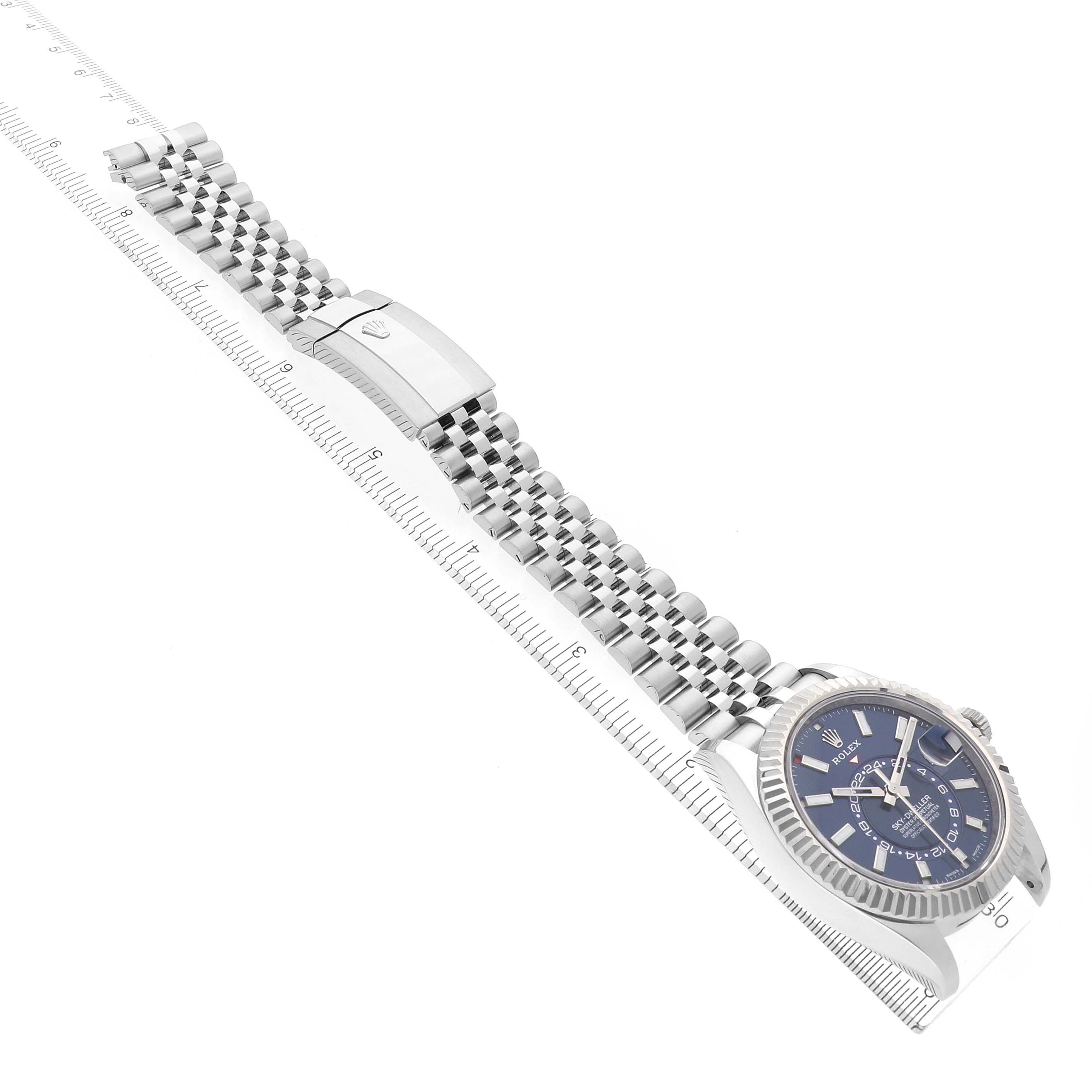 The Rolex Sky-Dweller 326934 Men's Stainless Steel Blue Dial 326934 Men's Stainless Steel Blue Dial watch is shown from a diagonal angle, highlighting the face, bezel, bracelet, and clasp.