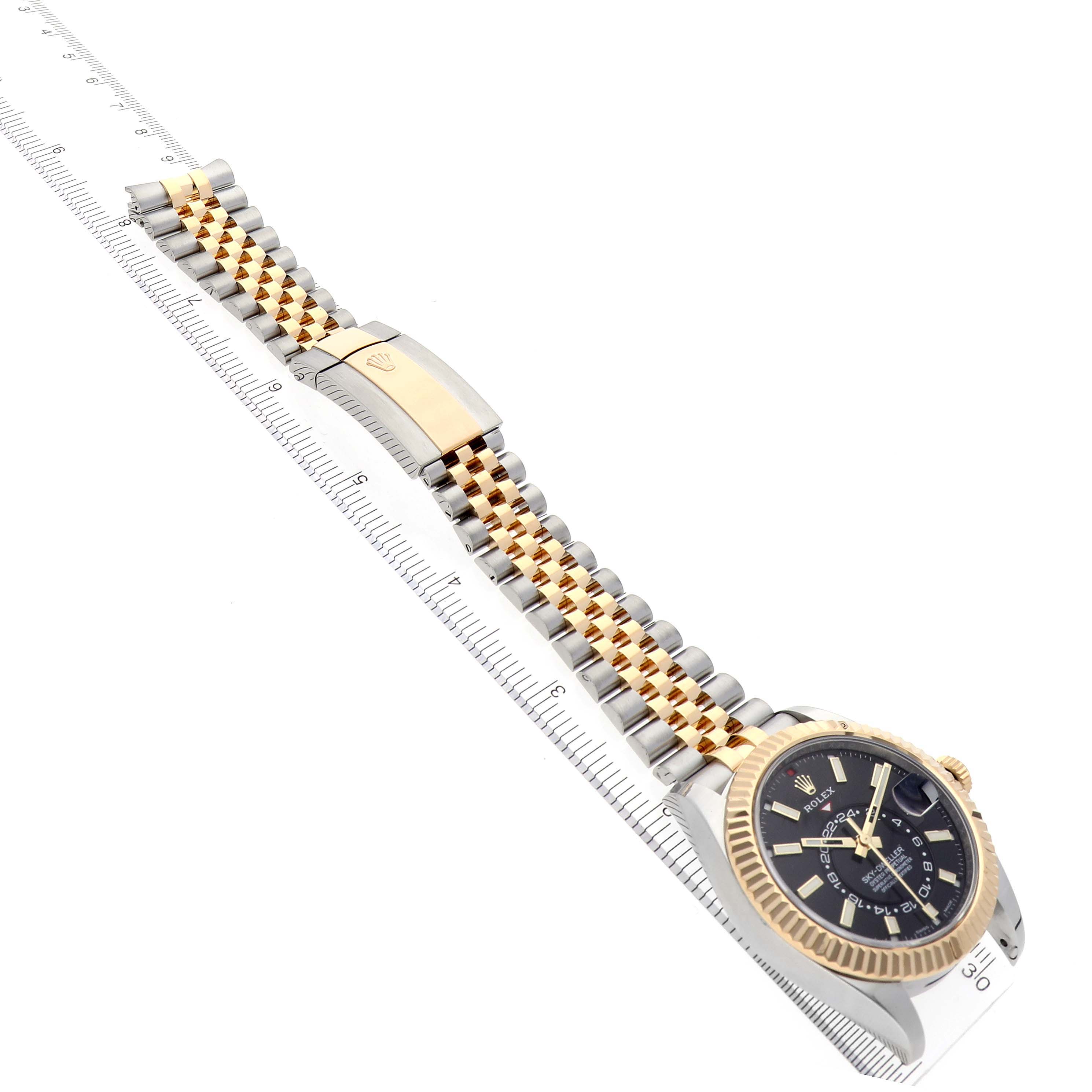 The Rolex Sky-Dweller 326933 Men's Steel and Gold (two tone) Black Dial 326933 Men's Steel and Gold (two tone) Black Dial watch is shown at an angled side view, highlighting the face and the two-tone bracelet.