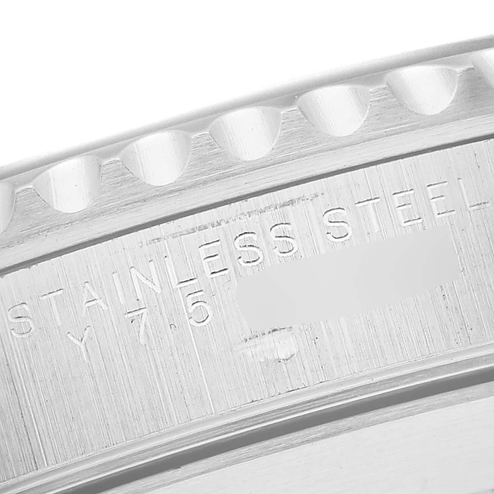 This close-up image shows the side engraving of a Rolex Submariner 14060M Men
s Stainless Steel Black Dial 14060M Men
s Stainless Steel Black Dial watch, highlighting the stainless steel text and a partial serial number.