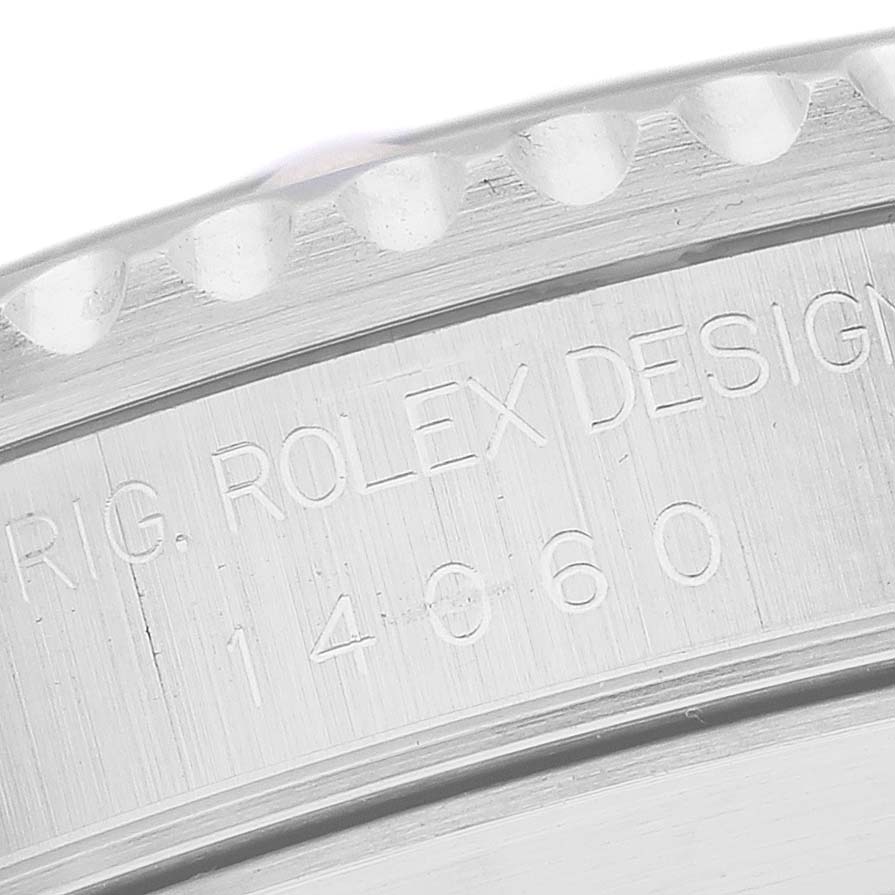 The image shows a close-up of the numbered engraving on the bezel and case of a Rolex Submariner 14060 Men
s Stainless Steel Black Dial 14060 Men
s Stainless Steel Black Dial.