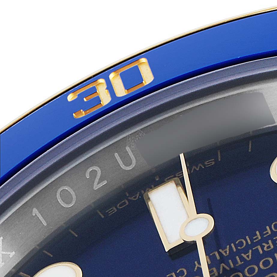 This close-up shows the bezel and a portion of the dial of the Rolex Submariner 116613 Men's Steel and Gold (two tone) Blue Dial 116613 Men's Steel and Gold (two tone) Blue Dial watch.