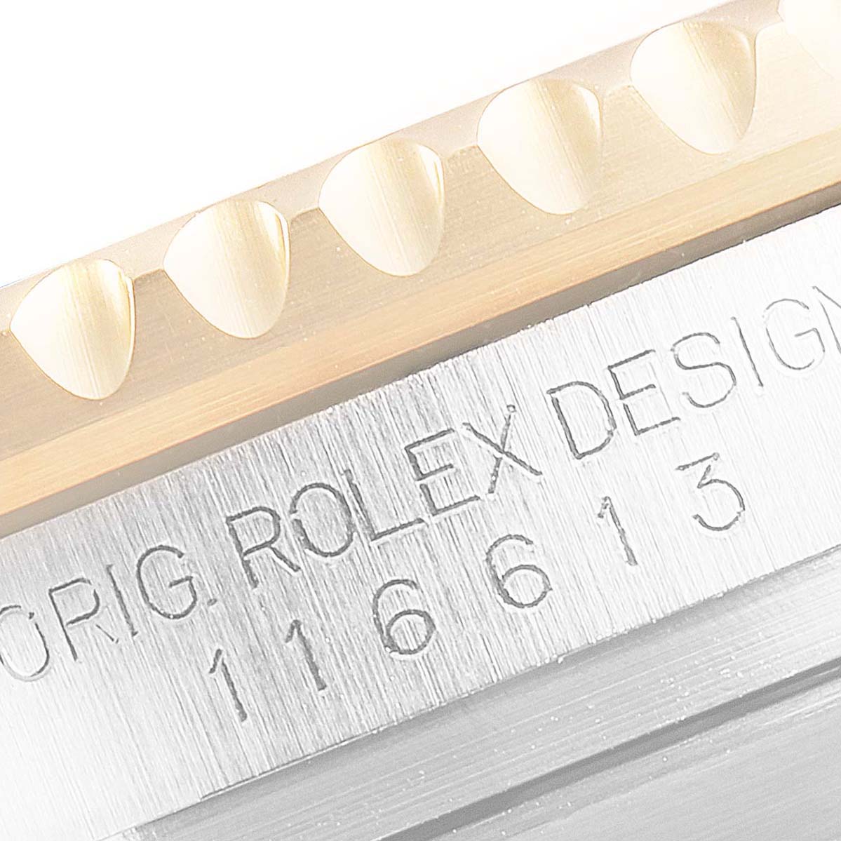 This close-up image shows part of the bezel and the engraved case of a Rolex Submariner 116613 Men's Steel and Gold (two tone) Blue Dial 116613 Men's Steel and Gold (two tone) Blue Dial model.