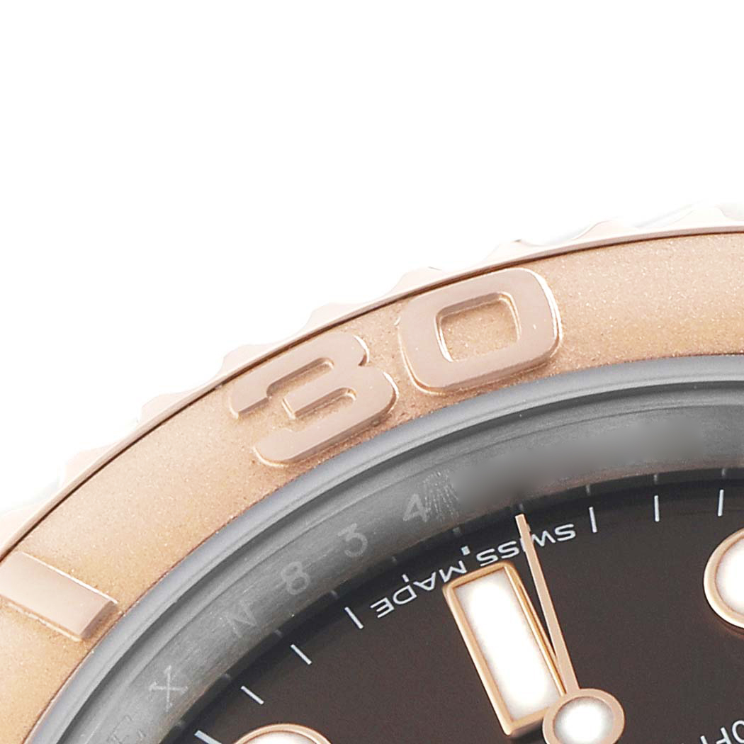 The image shows a detailed close-up of the Rolex Yacht-Master 116621 Men's Steel and Gold (two tone) Brown Dial watch's bezel, numeral, and part of the dial.
