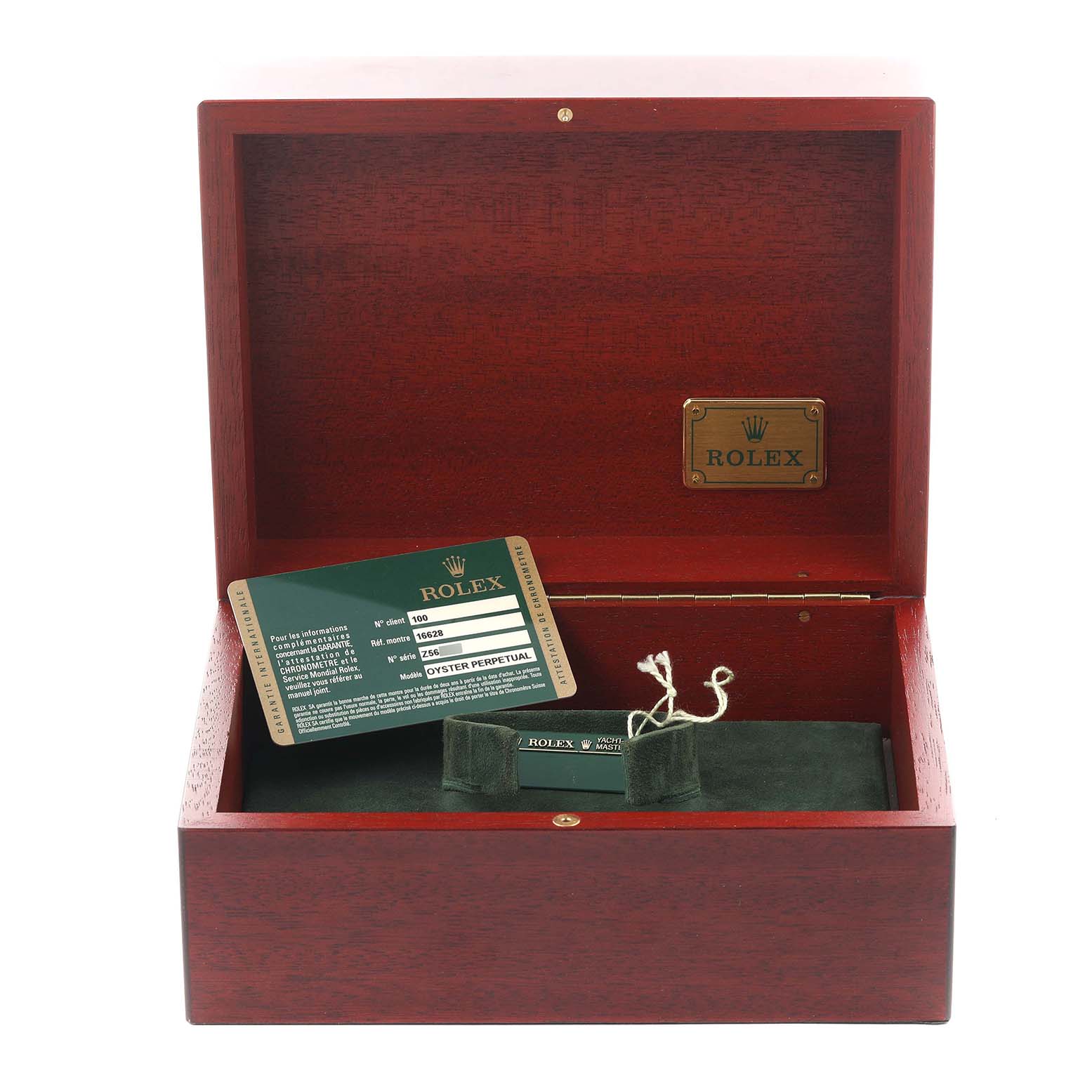 The image shows an open Rolex watch box for the Yacht-Master model, featuring an authenticity card and cloth pouch.