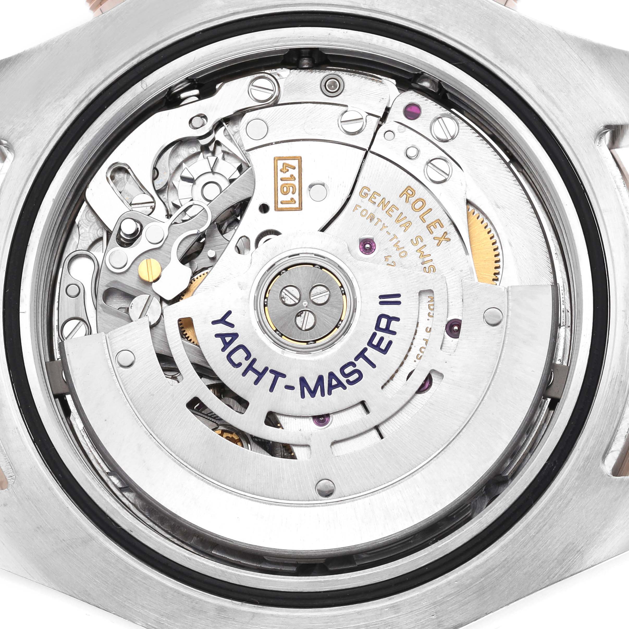 The image shows a close-up of the movement inside a Rolex Yacht-Master 116681M Men's Steel and Gold (two tone) White Dial II, focusing on the rotor and intricate internal components.