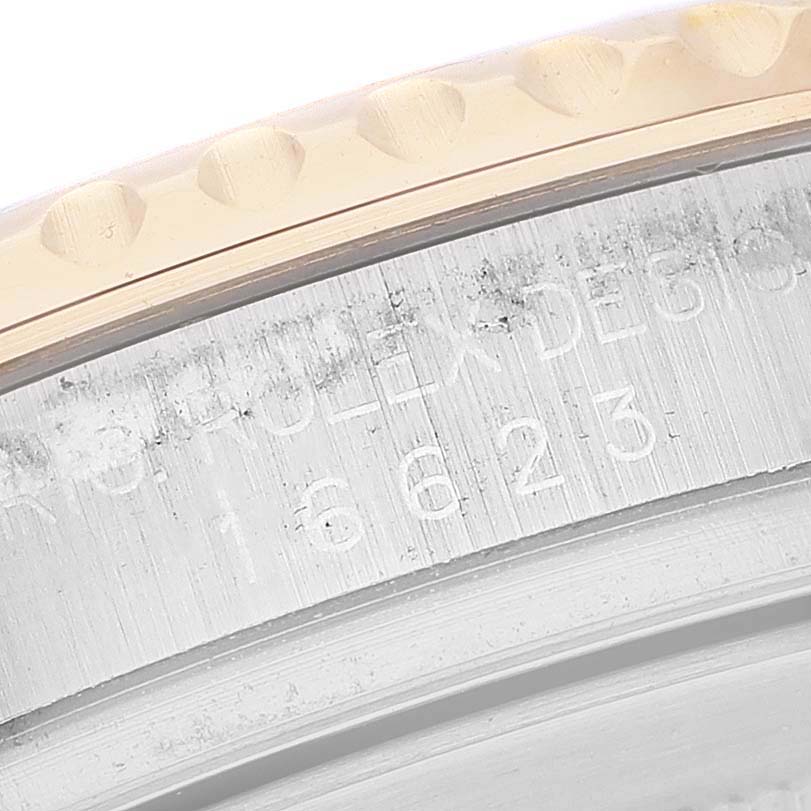 This close-up image shows the side engraving and part of the bezel of the Rolex Yacht-Master 16623 Men's Steel and Gold (two tone) White Dial 16623 Men's Steel and Gold (two tone) White Dial watch model.