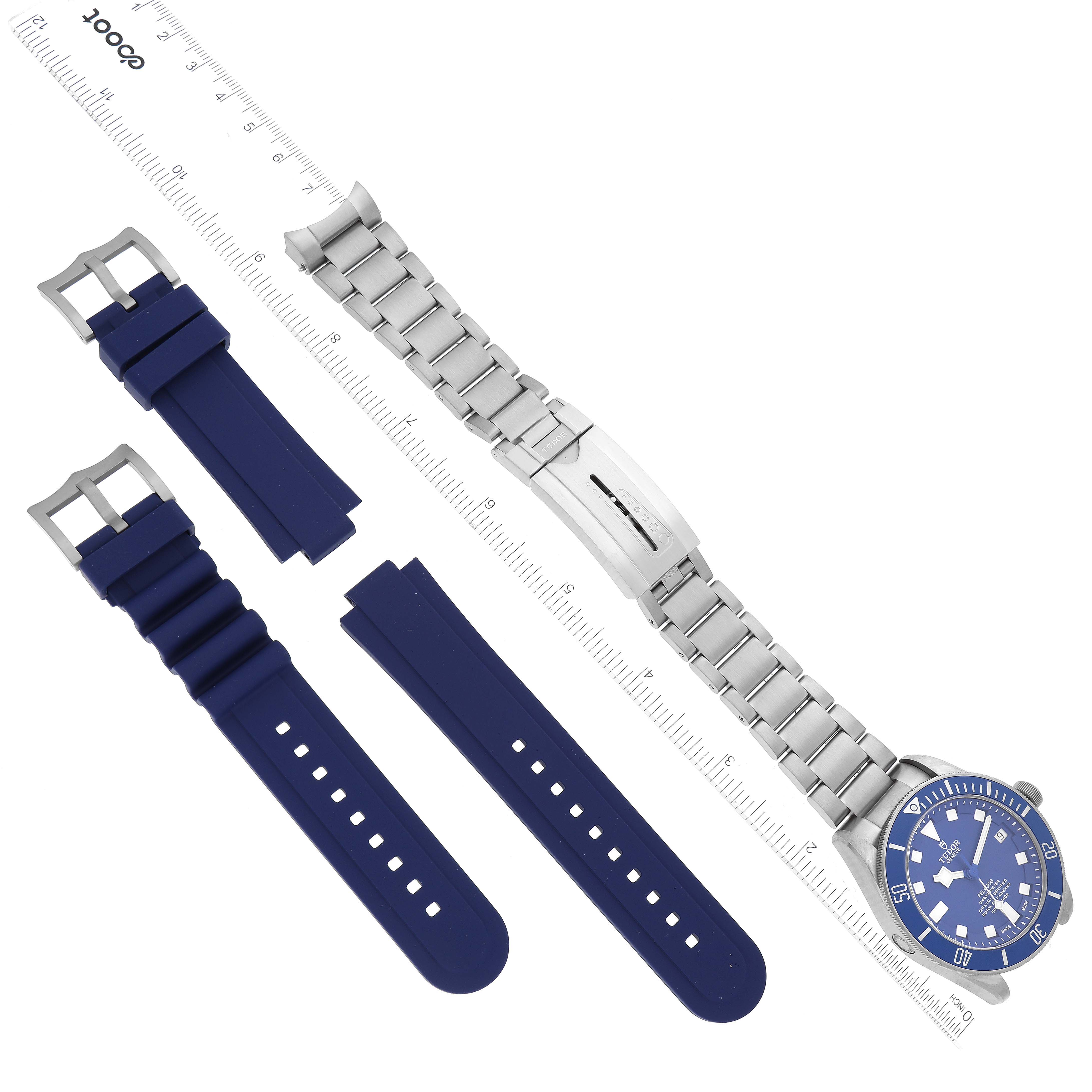 The image shows a Tudor Pelagos 25600TB-0001 Men's Titanium Blue Dial 25600TB-0001 Men's Titanium Blue Dial watch laying flat along with separate blue rubber straps and a metal bracelet.