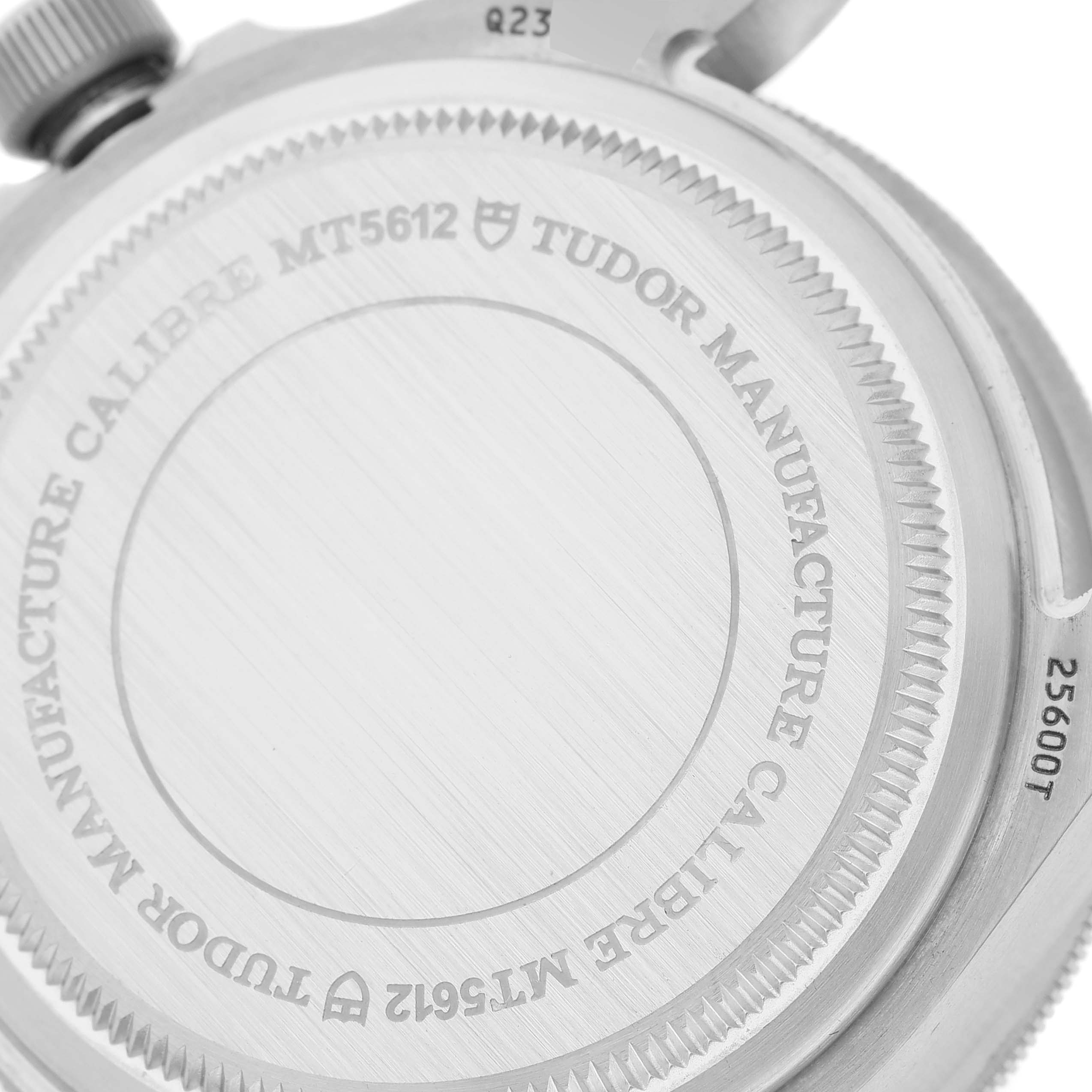 The image shows the back case and screw-down crown of the Tudor Pelagos 25600TB-0001 Men's Titanium Blue Dial 25600TB-0001 Men's Titanium Blue Dial watch, highlighting the "Manufacture Calibre MT5612" engraving.