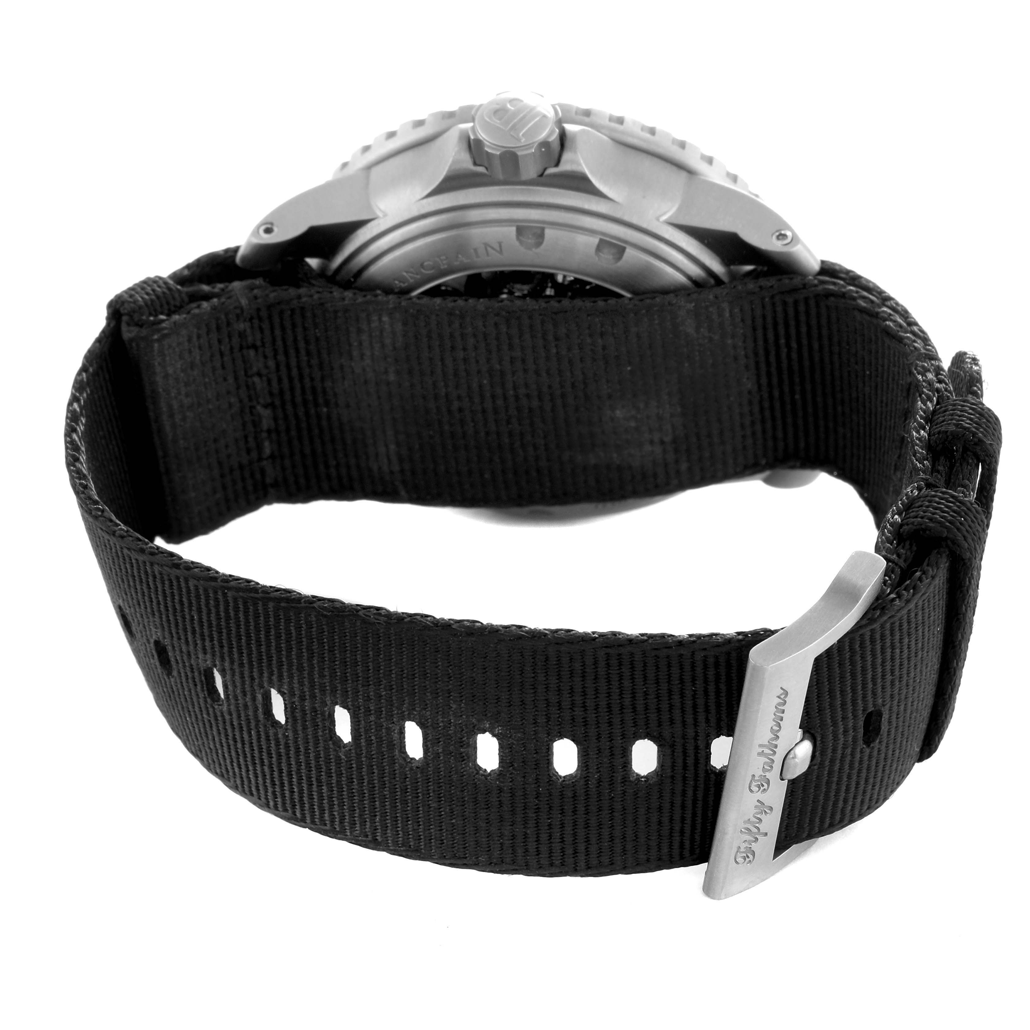 The image shows the back case and strap of the Blancpain Fifty Fathoms 5015-12B30 Men's Titanium Black Dial watch, highlighting the buckle and crown.