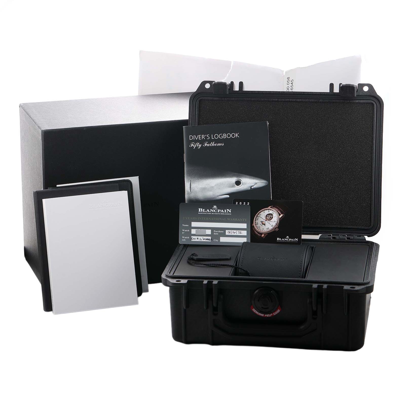 The image shows the packaging and accessories for the Blancpain Fifty Fathoms 5015-12B30 Men's Titanium Black Dial watch, including a diver's logbook and warranty card.