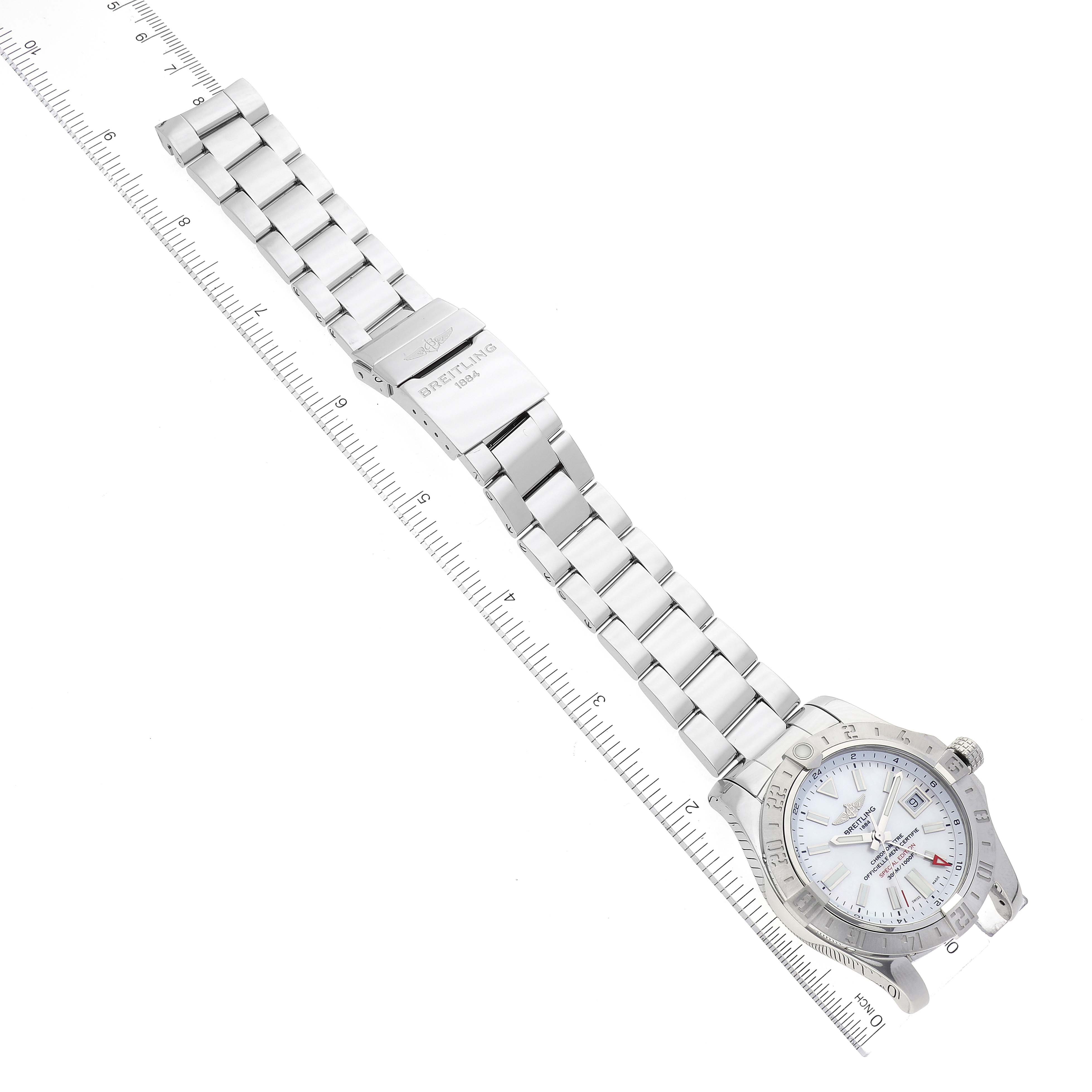 This image shows the Breitling Avenger A3239011-C872-170A Men's Stainless Steel Mother of Pearl Dial A3239011-C872-170A Men's Stainless Steel Mother of Pearl Dial watch laid flat with its full metal bracelet and clasp visible, alongside a measuring ruler.
