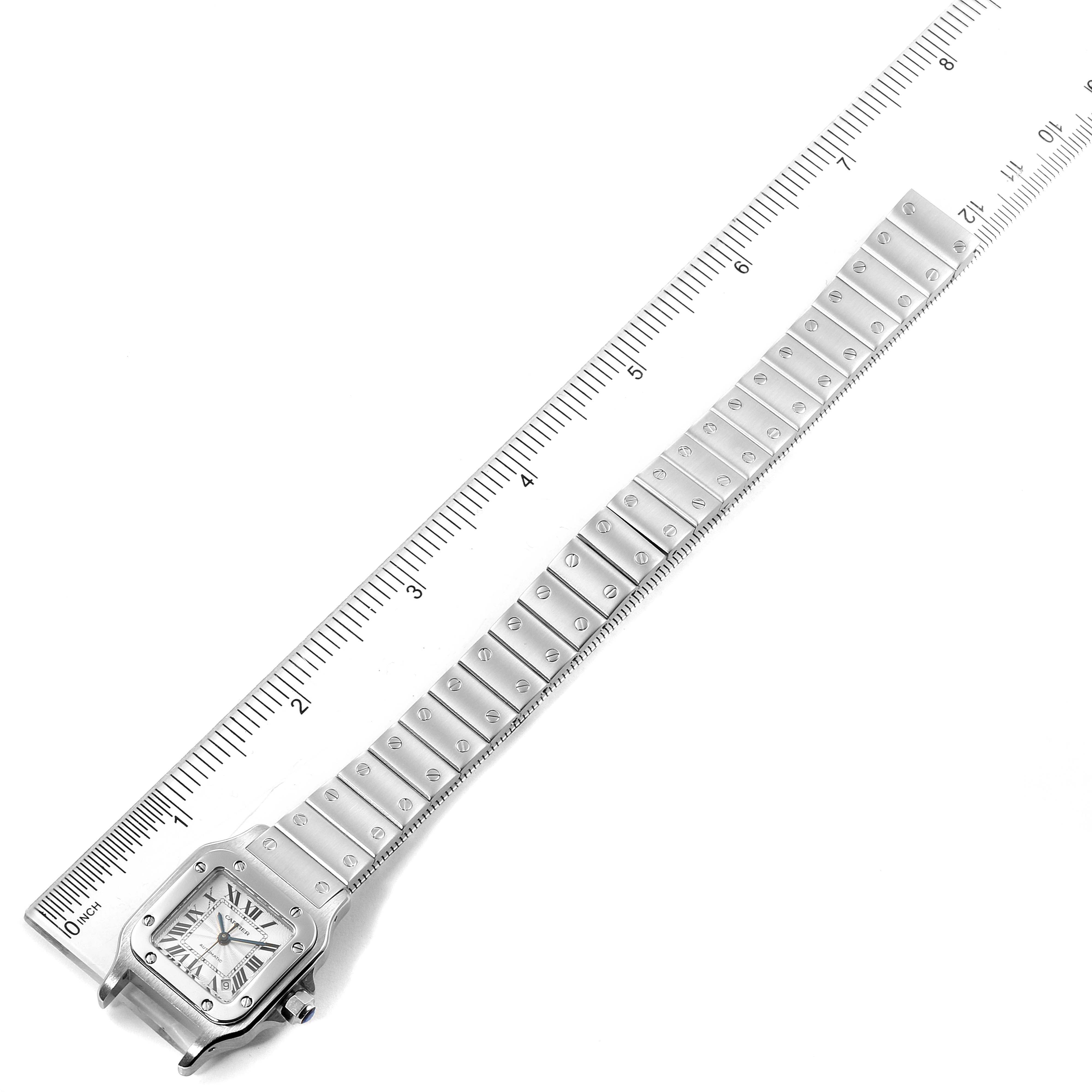 The image shows a top view of a Cartier Santos W20044D6 Women's Stainless Steel Silver Dial W20044D6 Women's Stainless Steel Silver Dial model watch with its bracelet fully extended and placed next to a ruler for measurement.