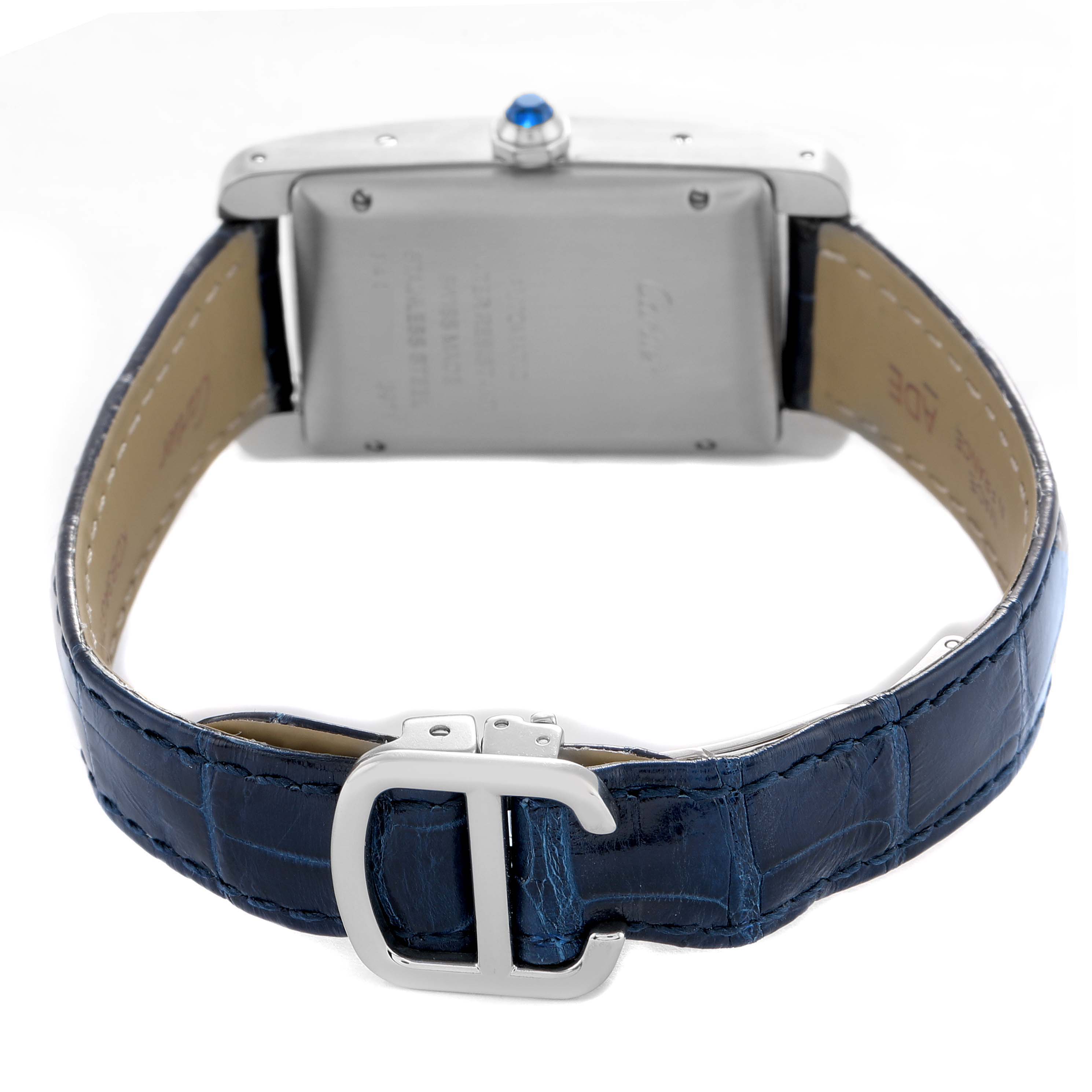 The image shows a Cartier Tank Americaine WSTA0017 Women's Stainless Steel Silver Dial watch from the back, highlighting the clasp and textured blue leather strap.