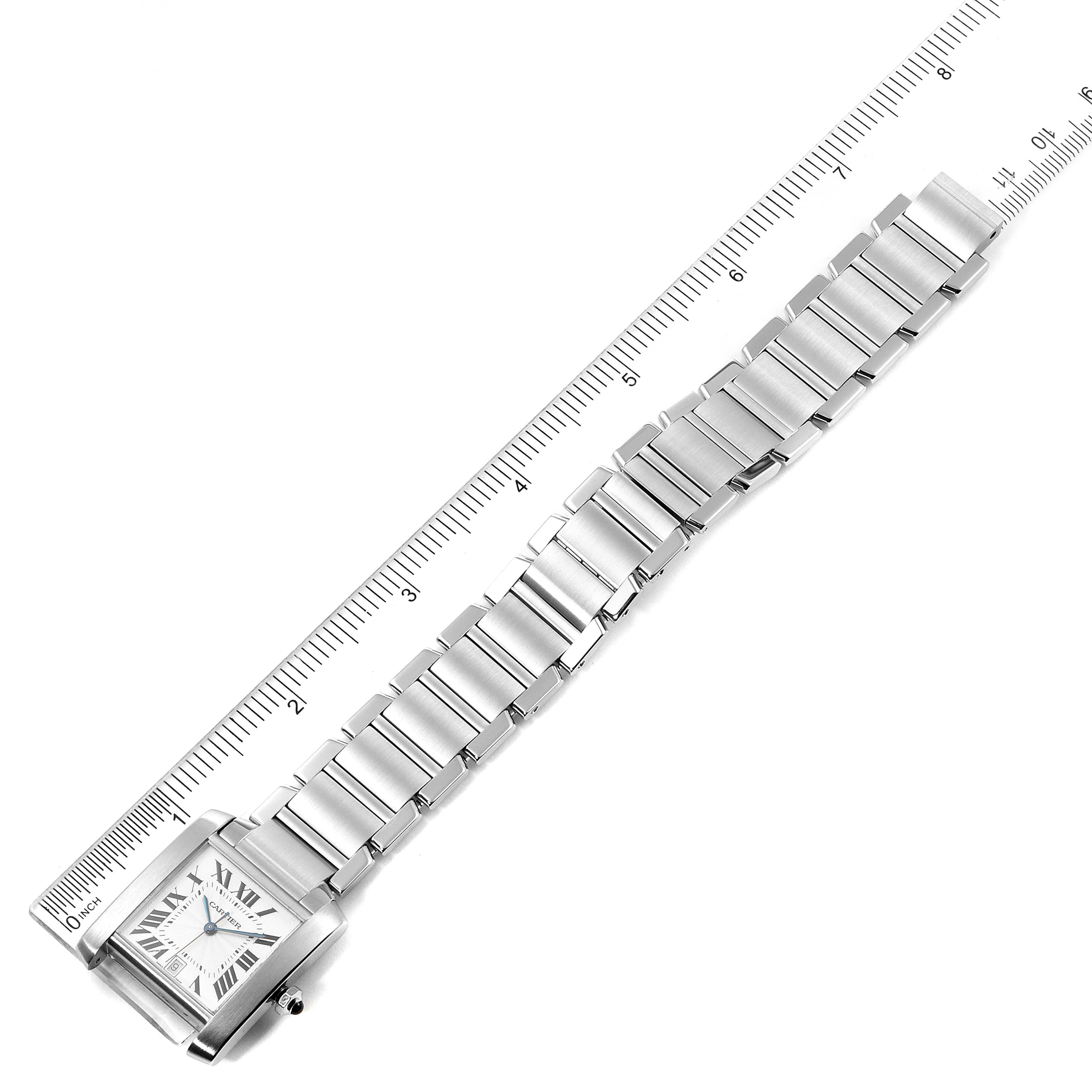 The image shows a Cartier Tank Francaise W51002Q3 Men's Stainless Steel Silver Dial W51002Q3 Men's Stainless Steel Silver Dial watch from a top-down angle, featuring its face and metal bracelet next to a ruler for size reference.
