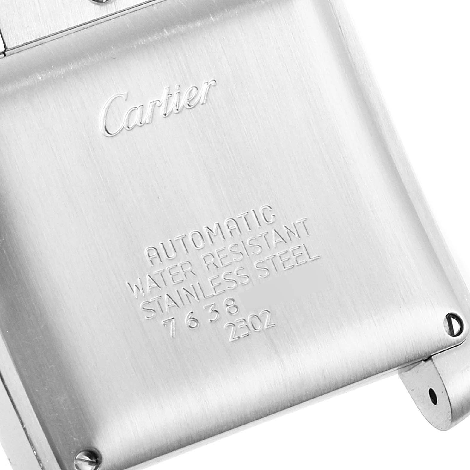 This image shows the back of the Cartier Tank Française watch, detailing its stainless steel case and inscriptions.