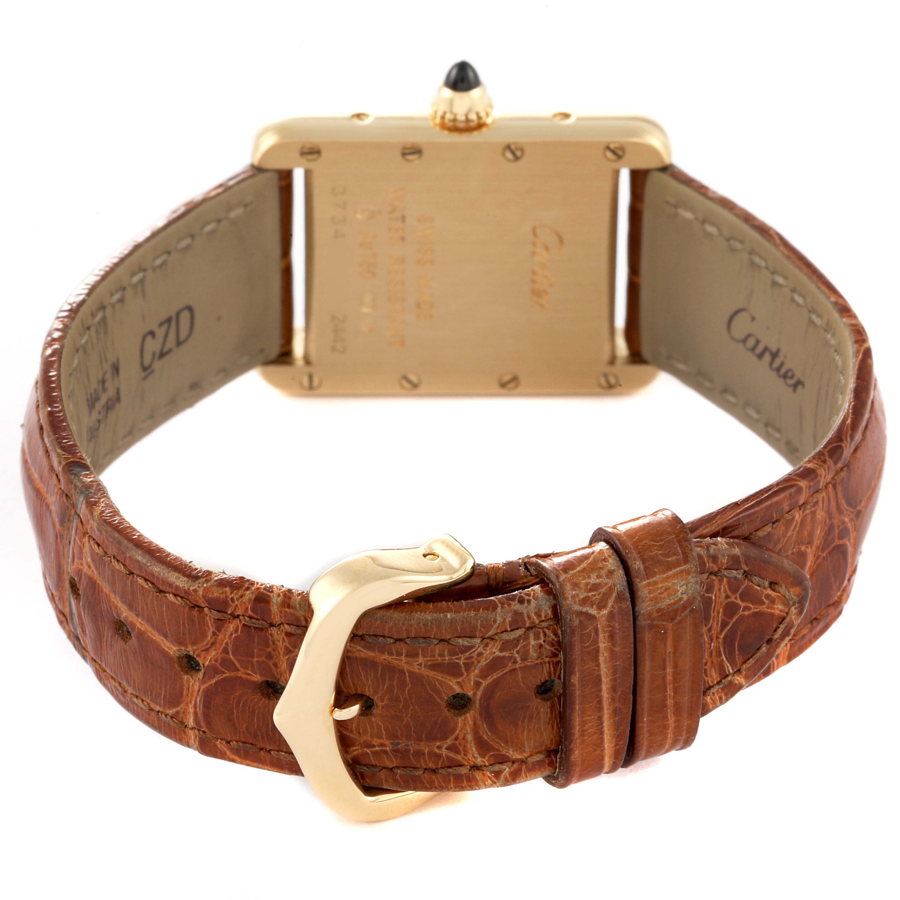 The Tank Louis watch by Cartier is shown from the back, highlighting the gold case and brown leather strap with a buckle.