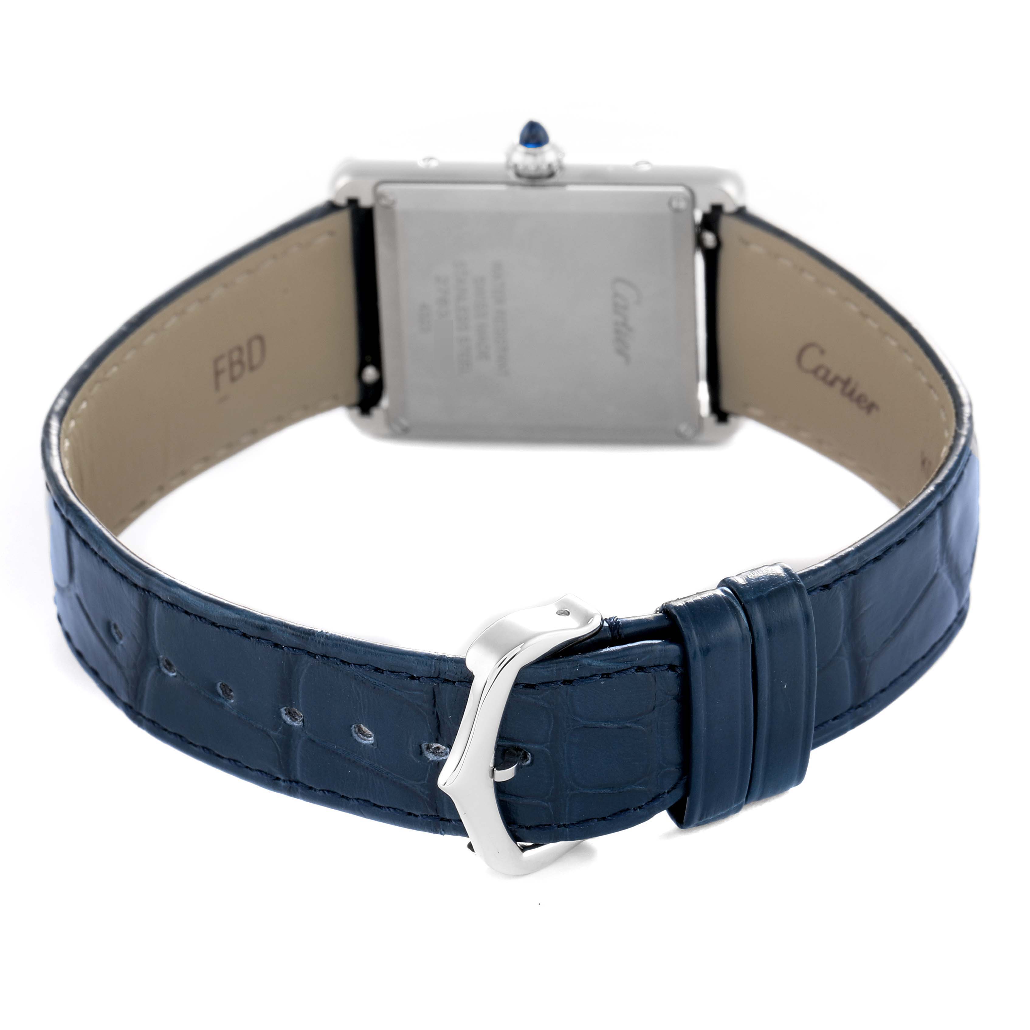 The image shows the back of a Cartier Tank Must WSTA0055 Women's Stainless Steel Blue Dial watch, highlighting the case back, crown, and blue leather strap with buckle.