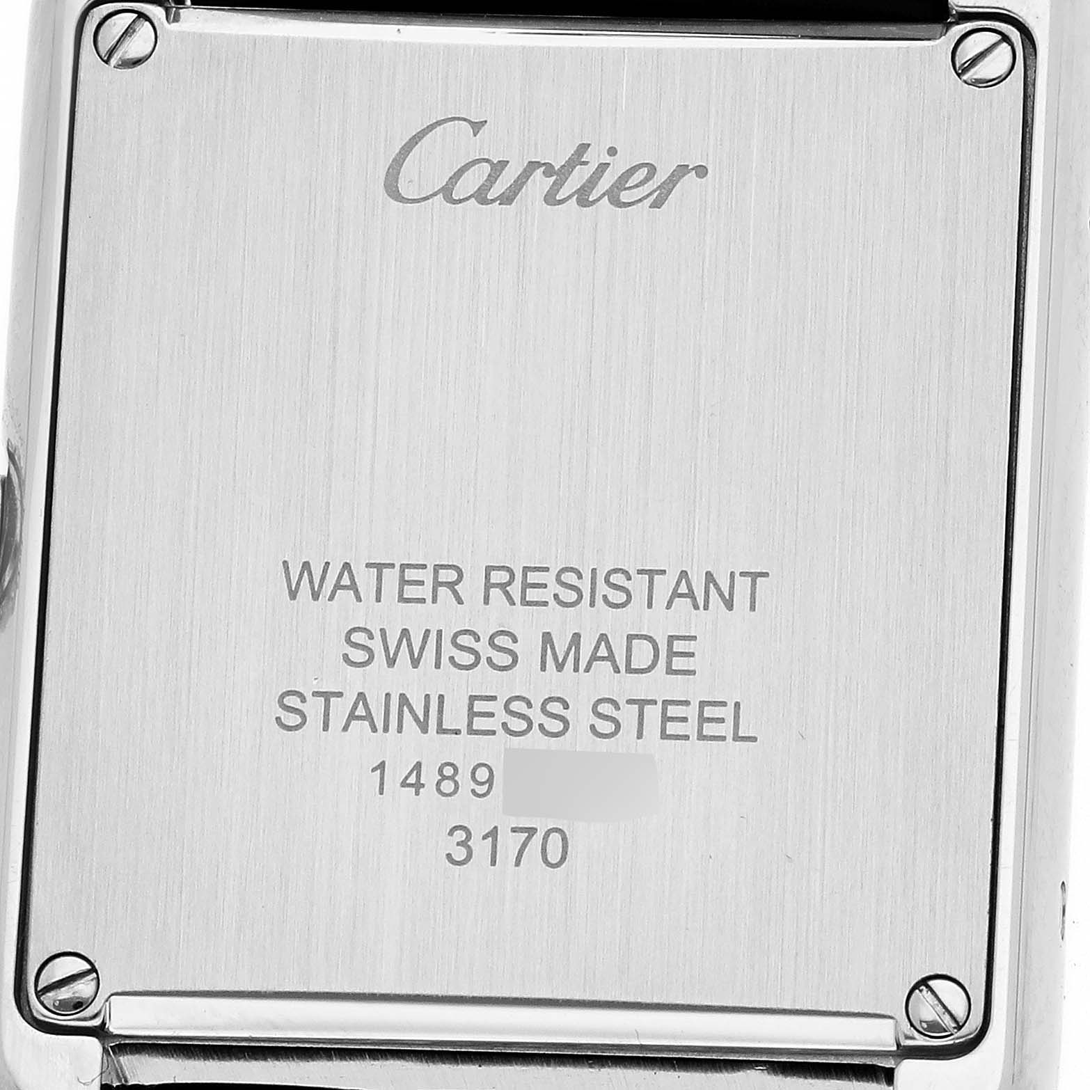 The image shows the stainless steel back of the Cartier Tank Solo WSTA0030 Women's Stainless Steel Silver Dial watch, highlighting the brand inscription and specifications.