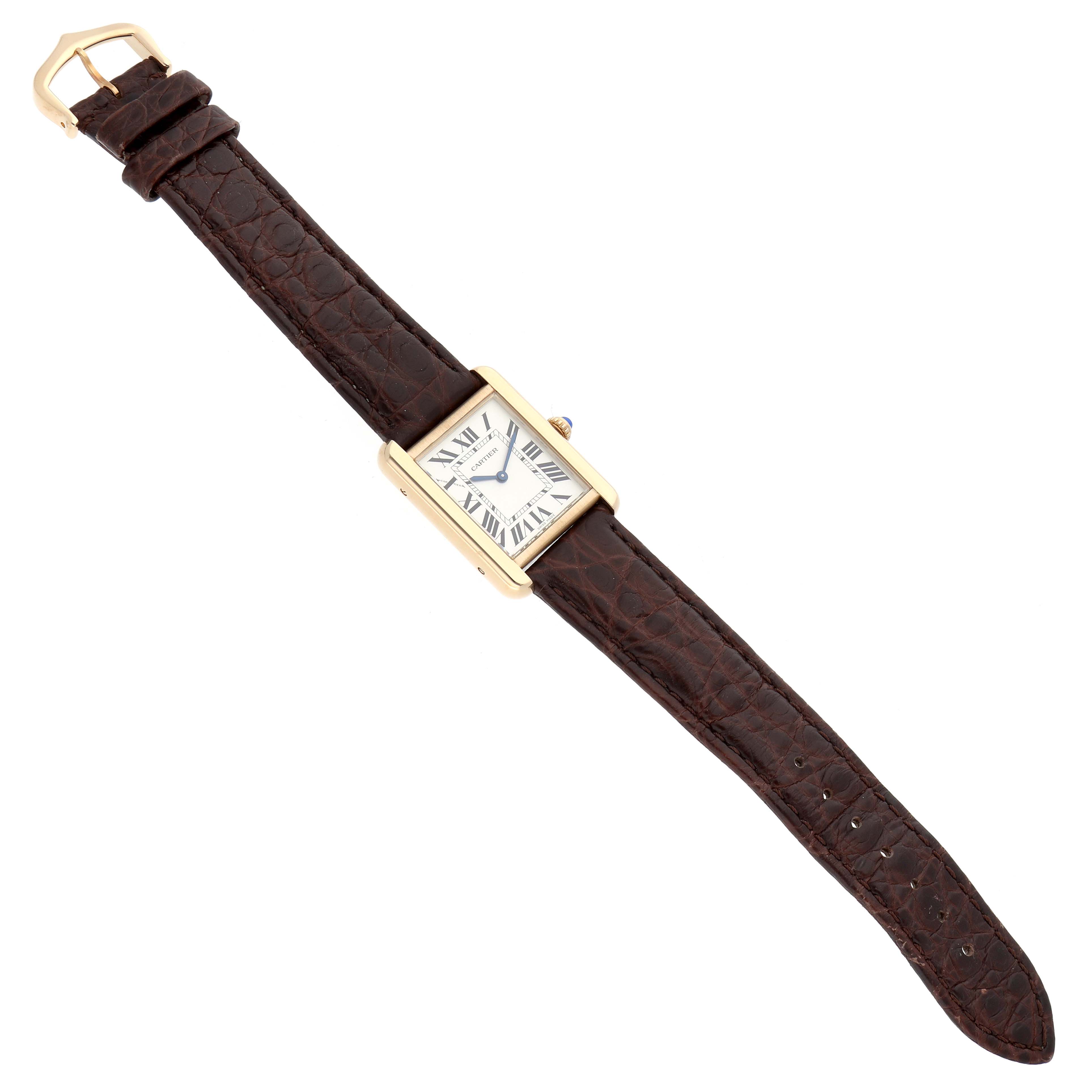 The Cartier Tank Solo W5200002 Women's Yellow Gold Silver Dial watch is shown at a slight angle, displaying its brown leather strap and rectangular face with Roman numerals.