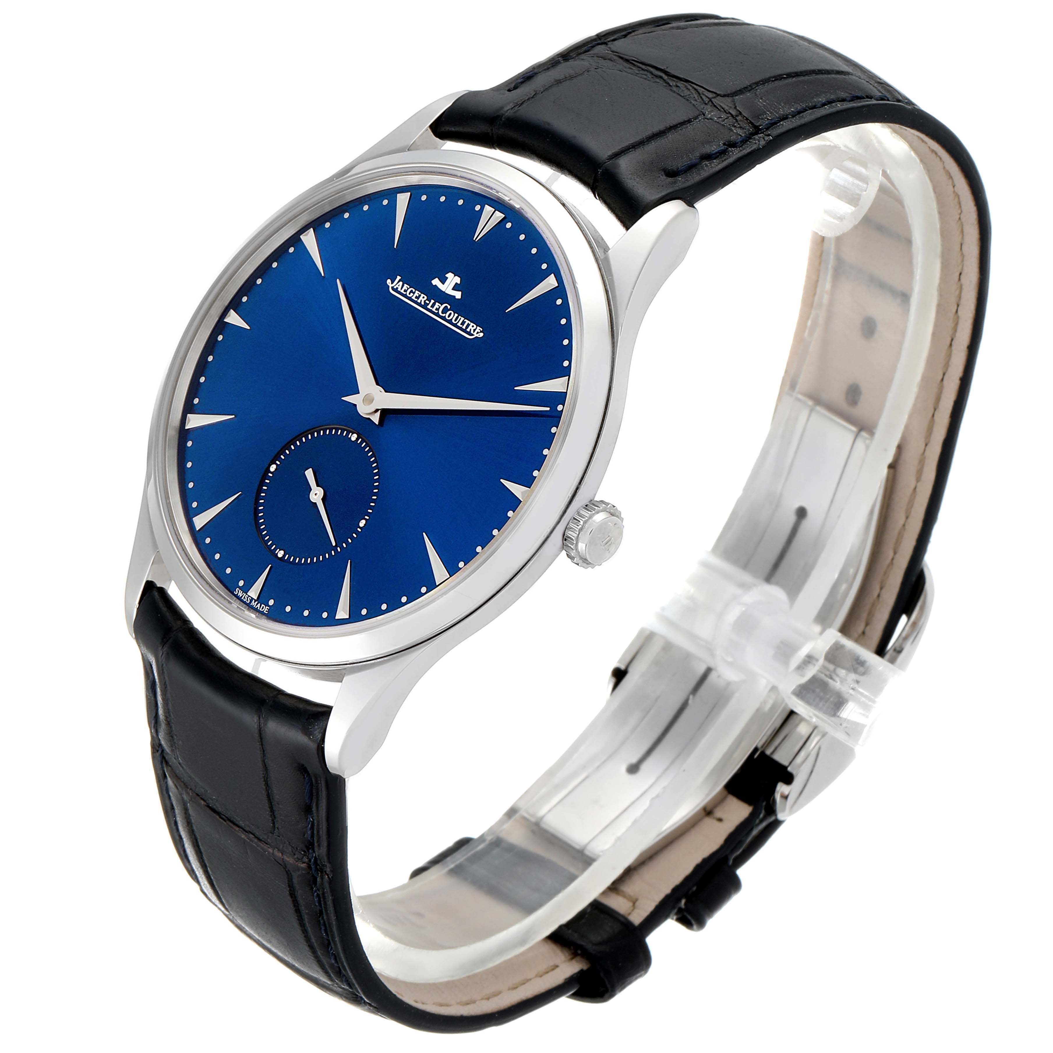 The Jaeger-LeCoultre Master model watch is shown at a side angle, displaying its blue dial, silver case, and black leather strap.
