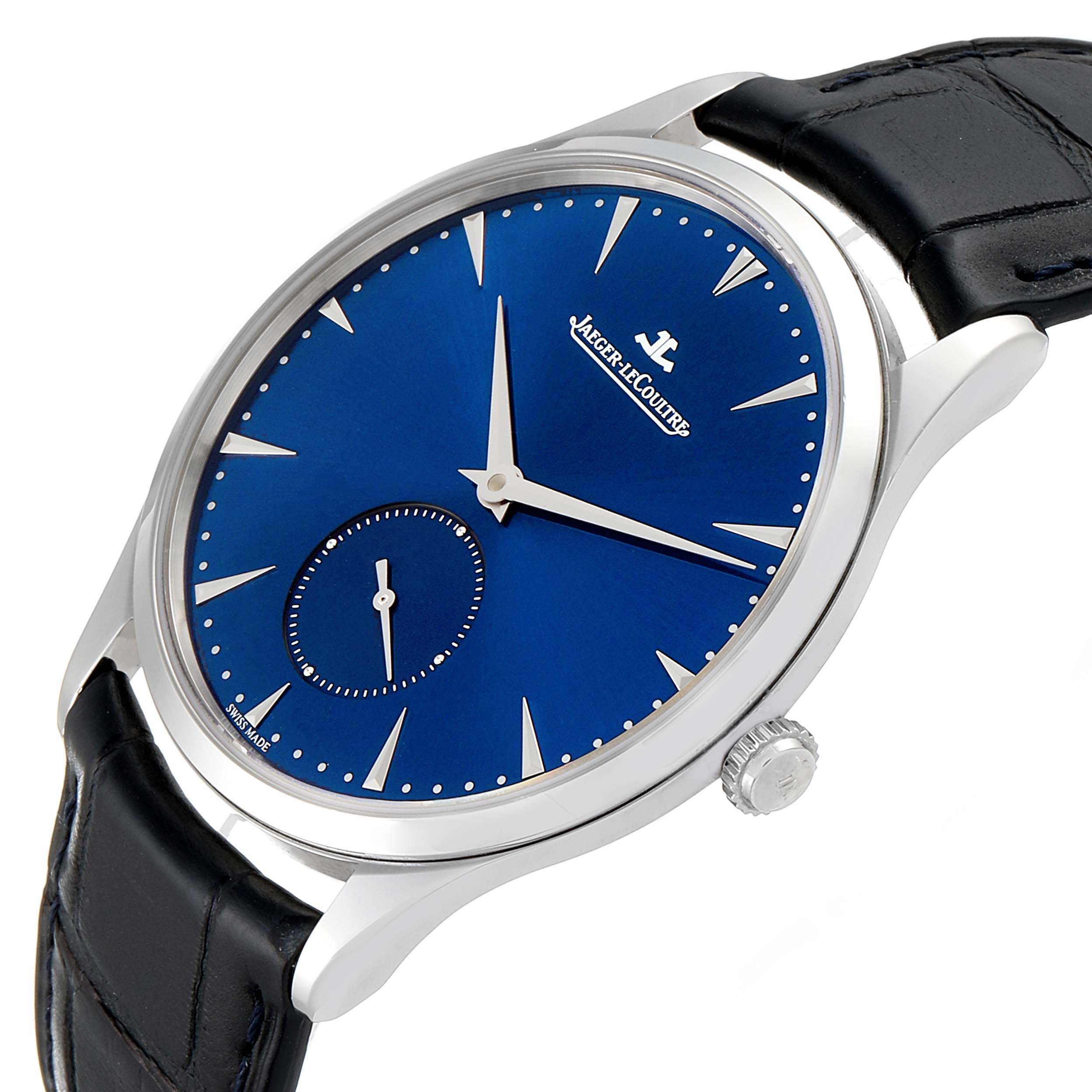 The image shows a Jaeger-LeCoultre Master model watch at a tilted angle, highlighting its blue dial, silver hands, crown, and black leather strap.