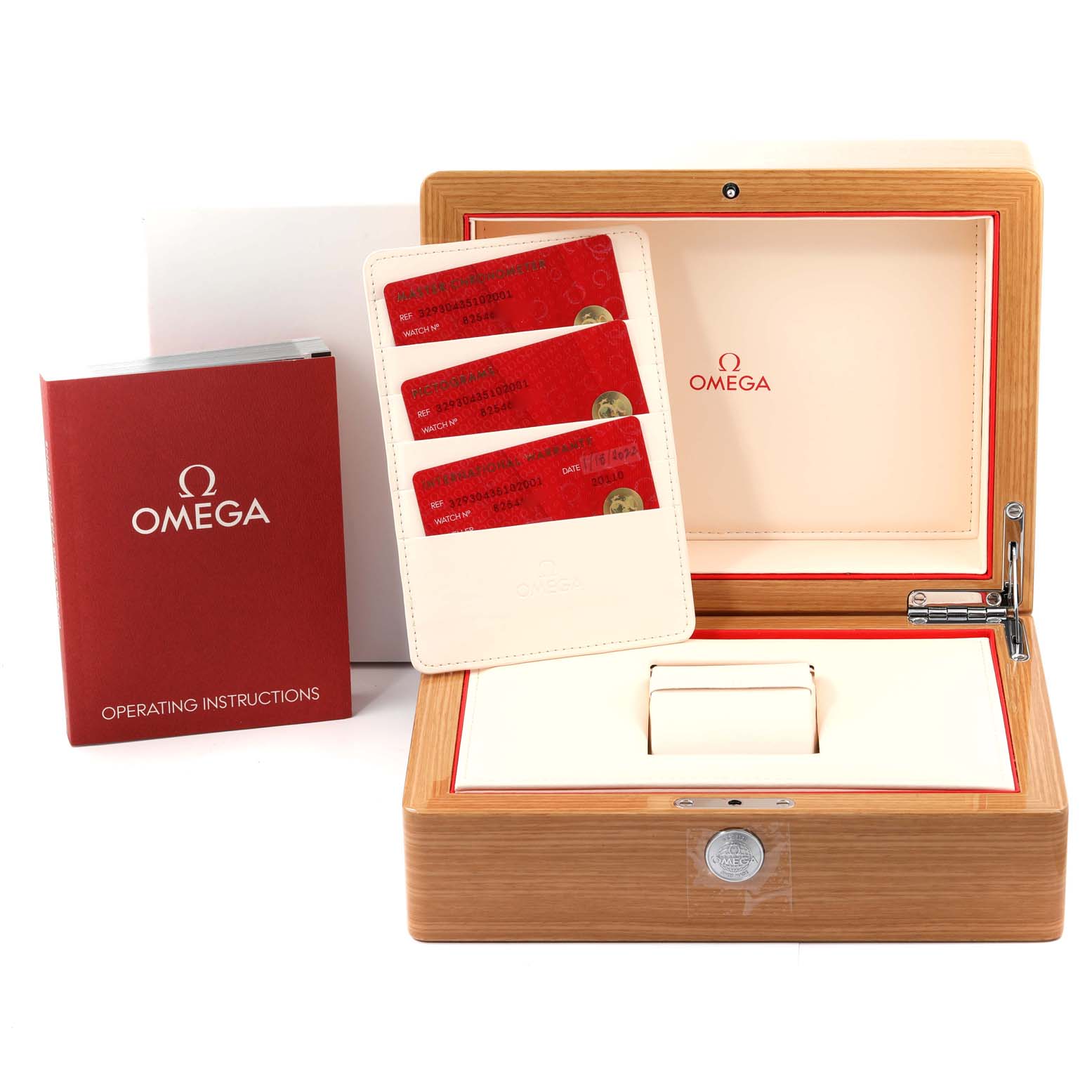 The image shows the packaging, operating instructions, and warranty cards for the Omega Speedmaster 329.30.43.51.02.001 Men's Stainless Steel Silver Dial 329.30.43.51.02.001 Men's Stainless Steel Silver Dial watch.