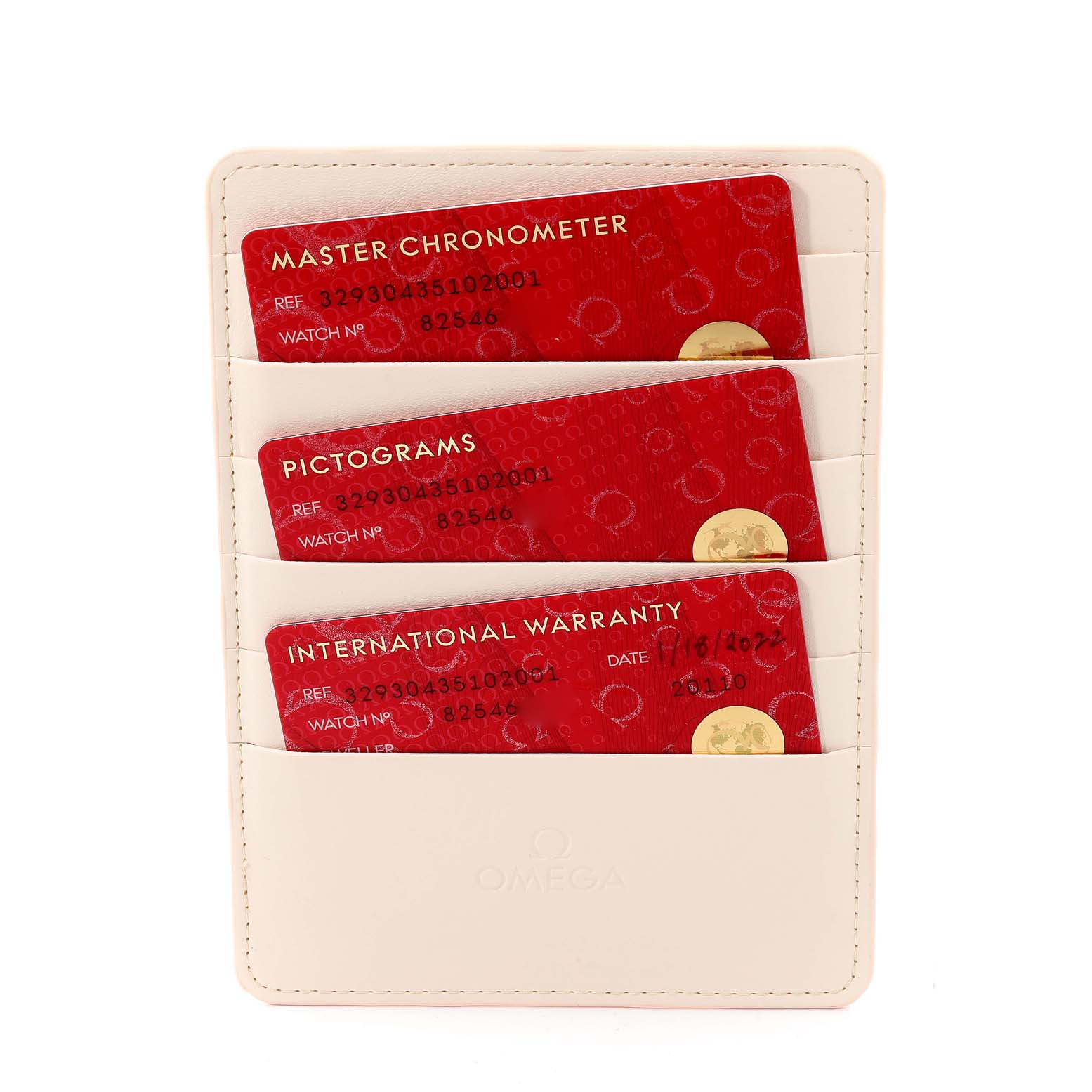 The image shows the warranty cards for an Omega Speedmaster 329.30.43.51.02.001 Men's Stainless Steel Silver Dial 329.30.43.51.02.001 Men's Stainless Steel Silver Dial, held in a white cardholder.