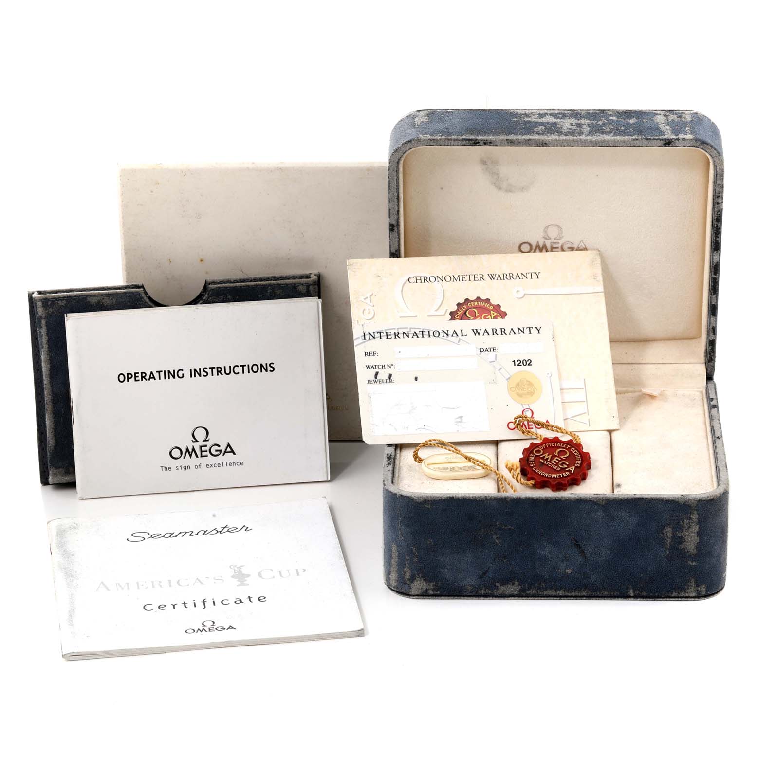 The image shows an Omega Seamaster 2533.50.00 Men's Stainless Steel Black Dial 2533.50.00 Men's Stainless Steel Black Dial watch box, operating instructions, warranty card, and certificate at an angle suggesting they're laid on a flat surface.