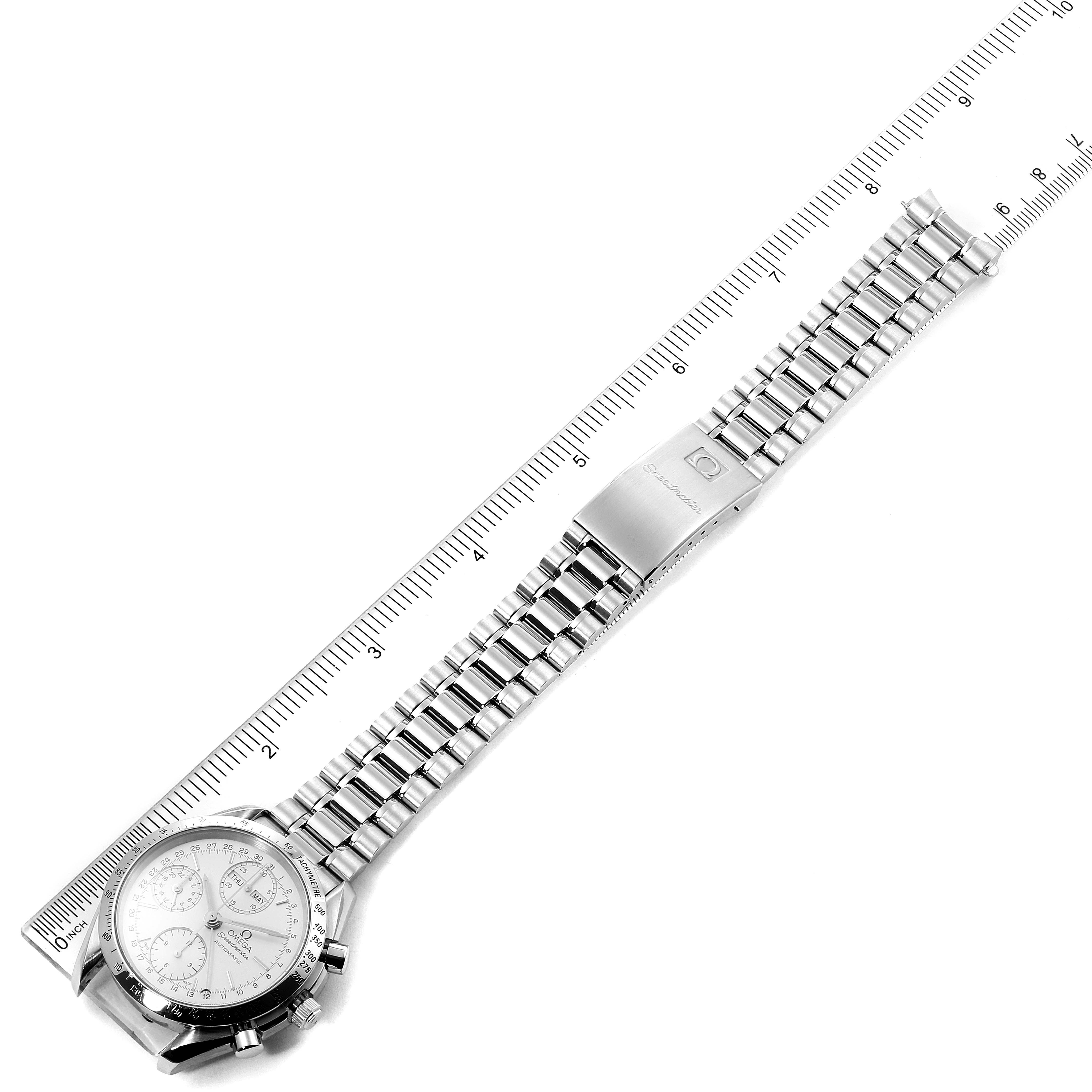 The image shows an Omega Speedmaster 3521.30.00 Men's Stainless Steel Silver Dial 3521.30.00 Men's Stainless Steel Silver Dial watch laid flat with a metal bracelet alongside a ruler for scale.