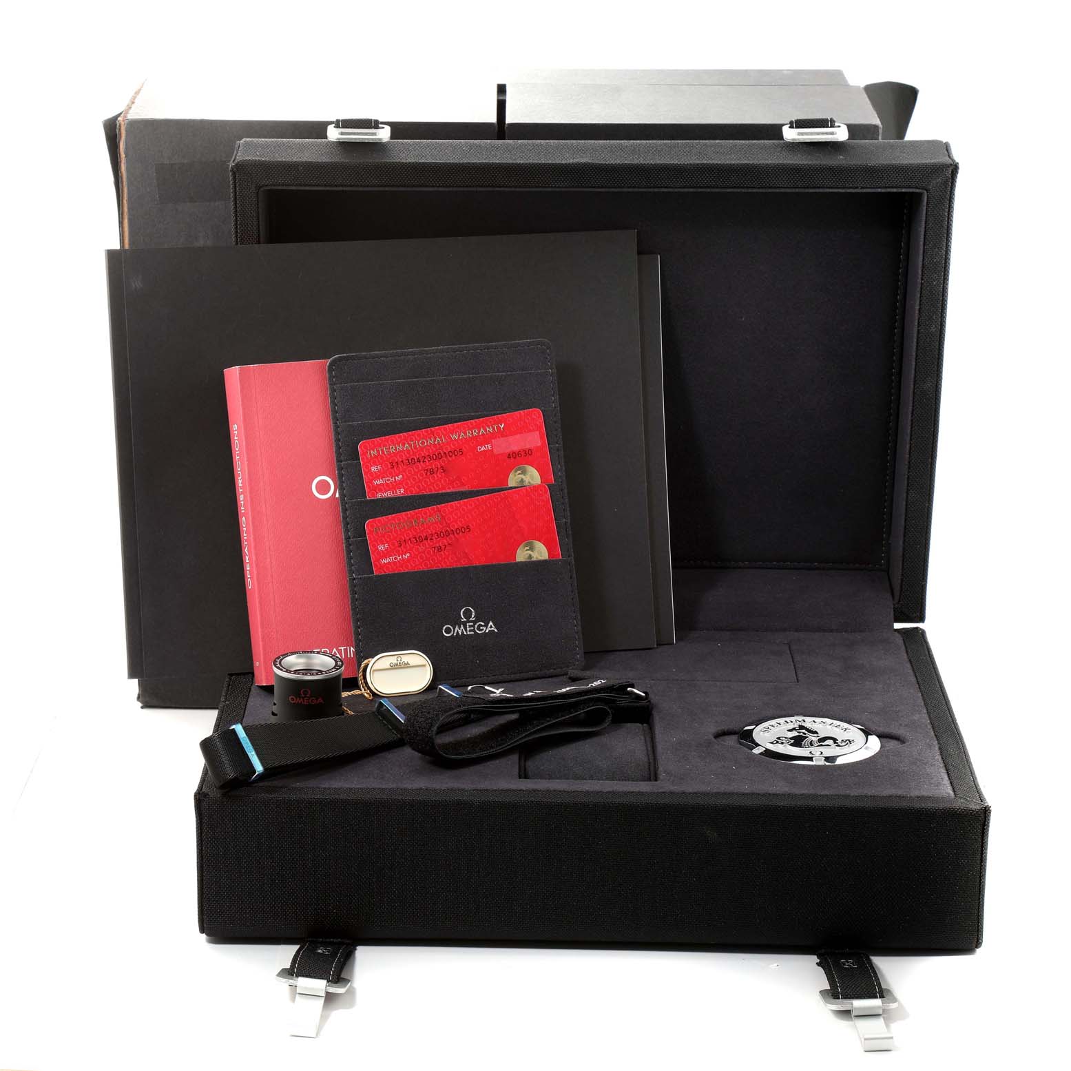 The image shows an unboxing of an Omega Speedmaster 311.30.42.30.01.005 Men
s Stainless Steel Black Dial 311.30.42.30.01.005 Men
s Stainless Steel Black Dial watch, including documents, warranty cards, and accessories from a top-front angle.