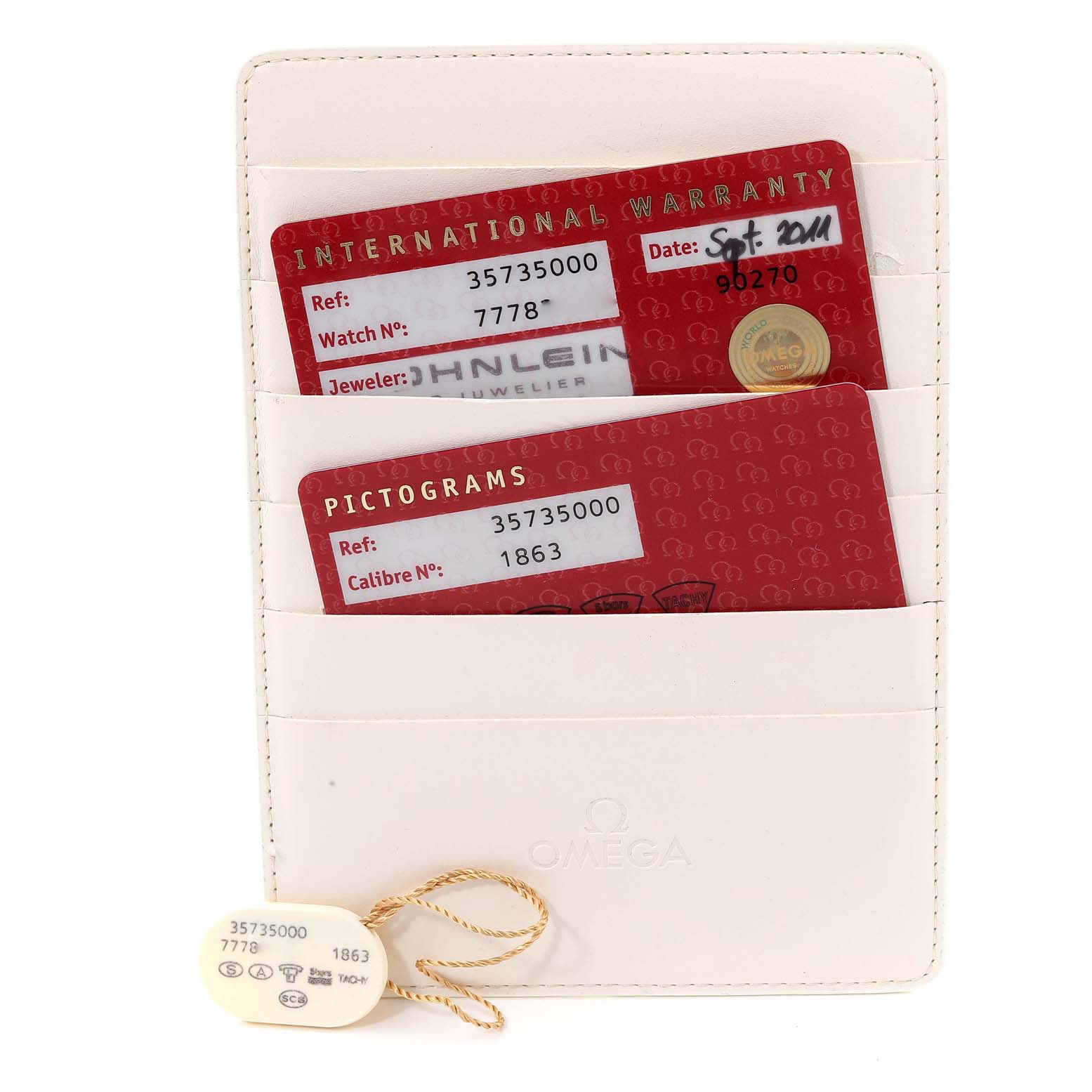 The image shows an Omega Speedmaster 3573.50.00 Men
s Stainless Steel Black Dial 3573.50.00 Men
s Stainless Steel Black Dial
s warranty cards and pictogram cards held in a white cardholder.