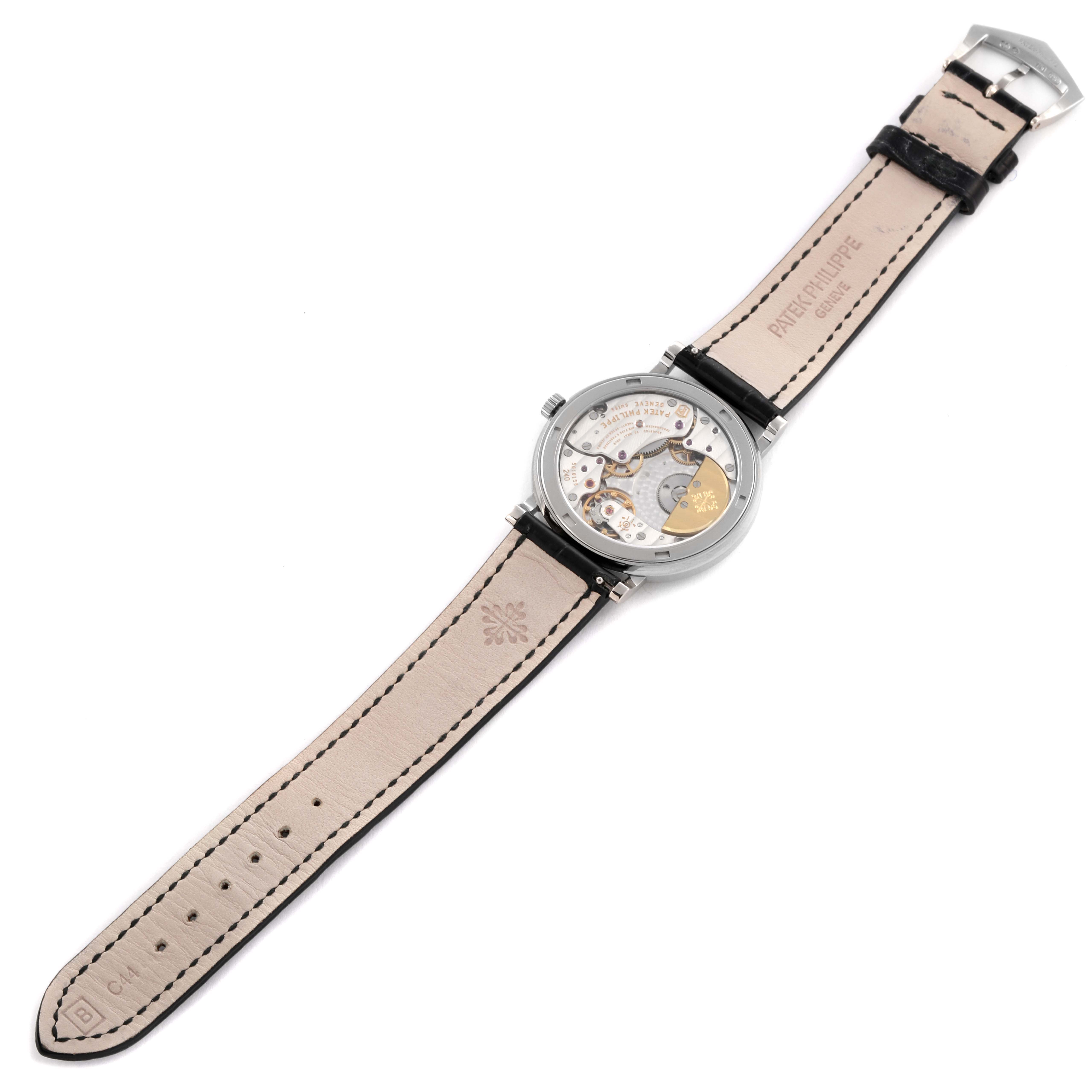 The Patek Philippe Calatrava 5120G-001 Men's White Gold White Dial 5120G-001 Men's White Gold White Dial watch is shown from the back, highlighting the movement and the full leather strap.