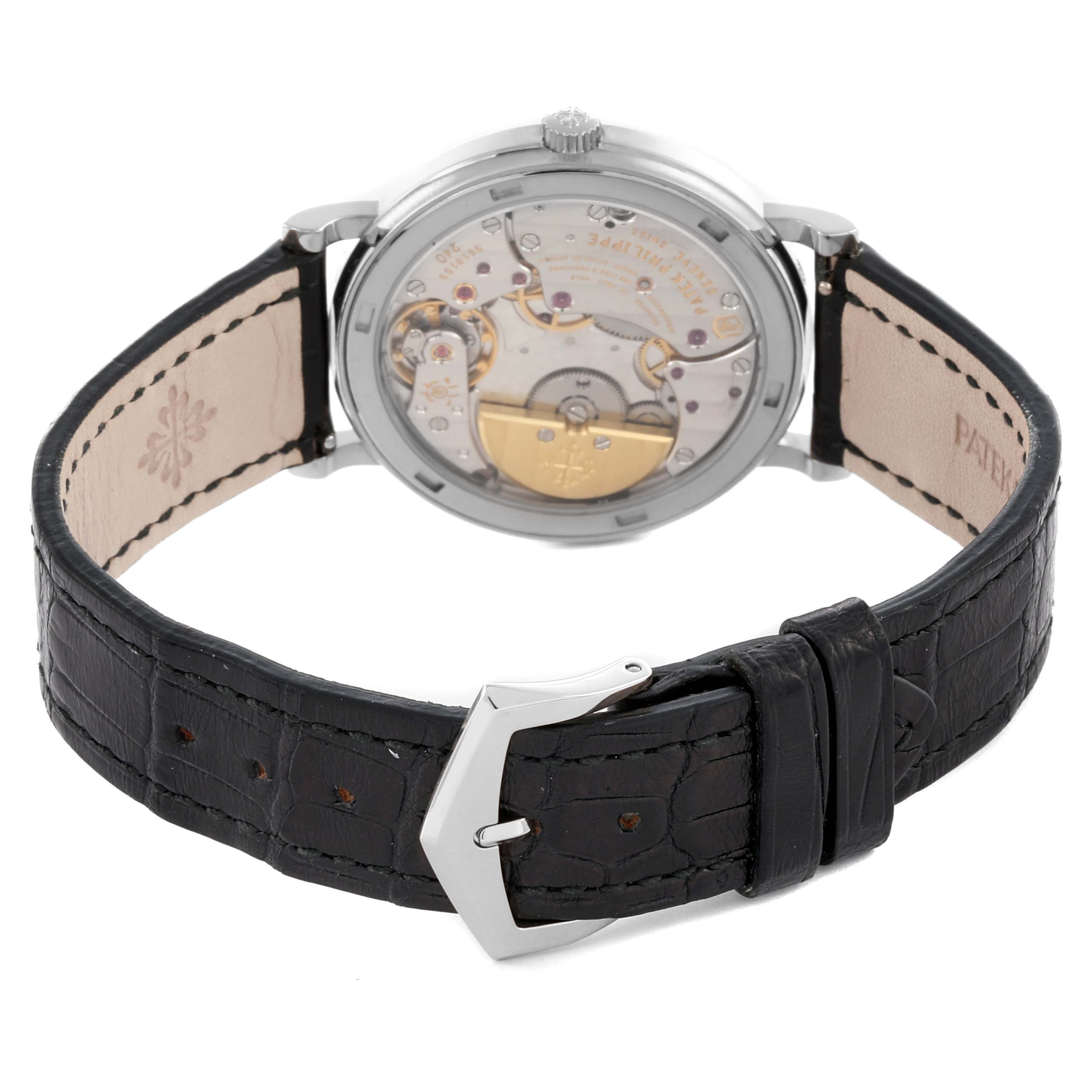 The image shows the back view of the Patek Philippe Calatrava 5120G-001 Men's White Gold White Dial 5120G-001 Men's White Gold White Dial, highlighting its movement and black leather strap.