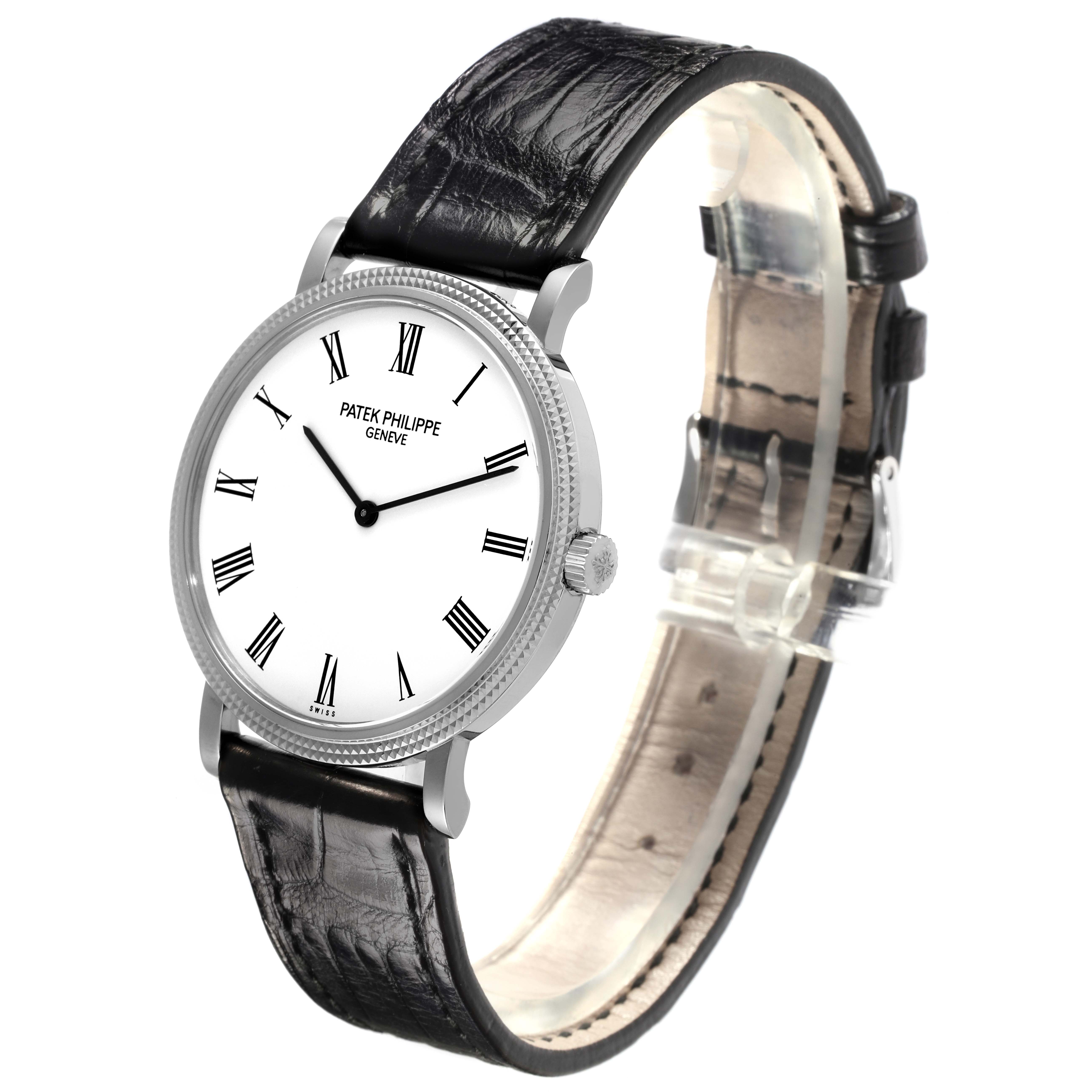 The Patek Philippe Calatrava 5120G-001 Men's White Gold White Dial 5120G-001 Men's White Gold White Dial watch is shown at an angle, highlighting the face, roman numerals, crown, and black leather strap.